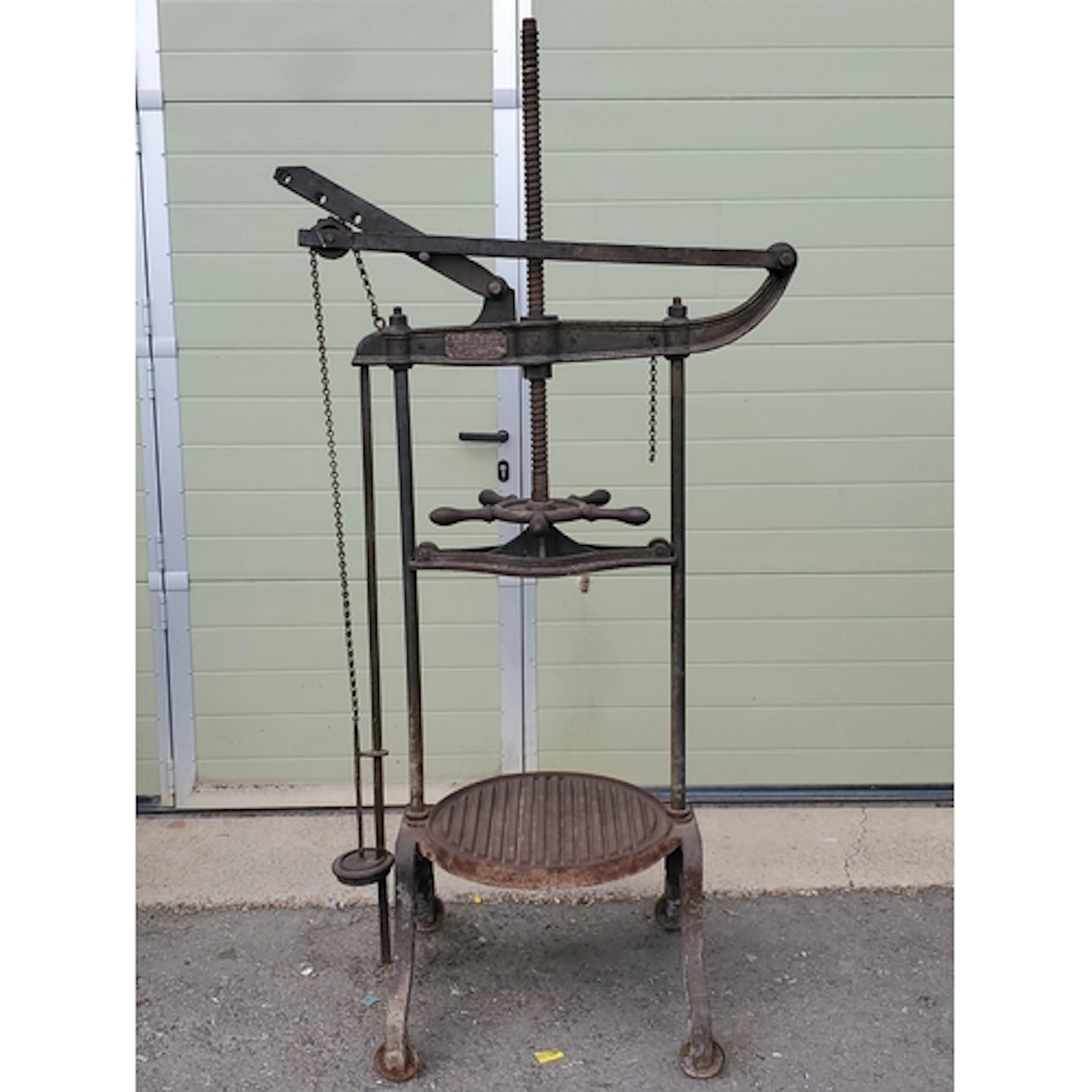 An antique cheese Press By 'Turner Bros, Newtown'.