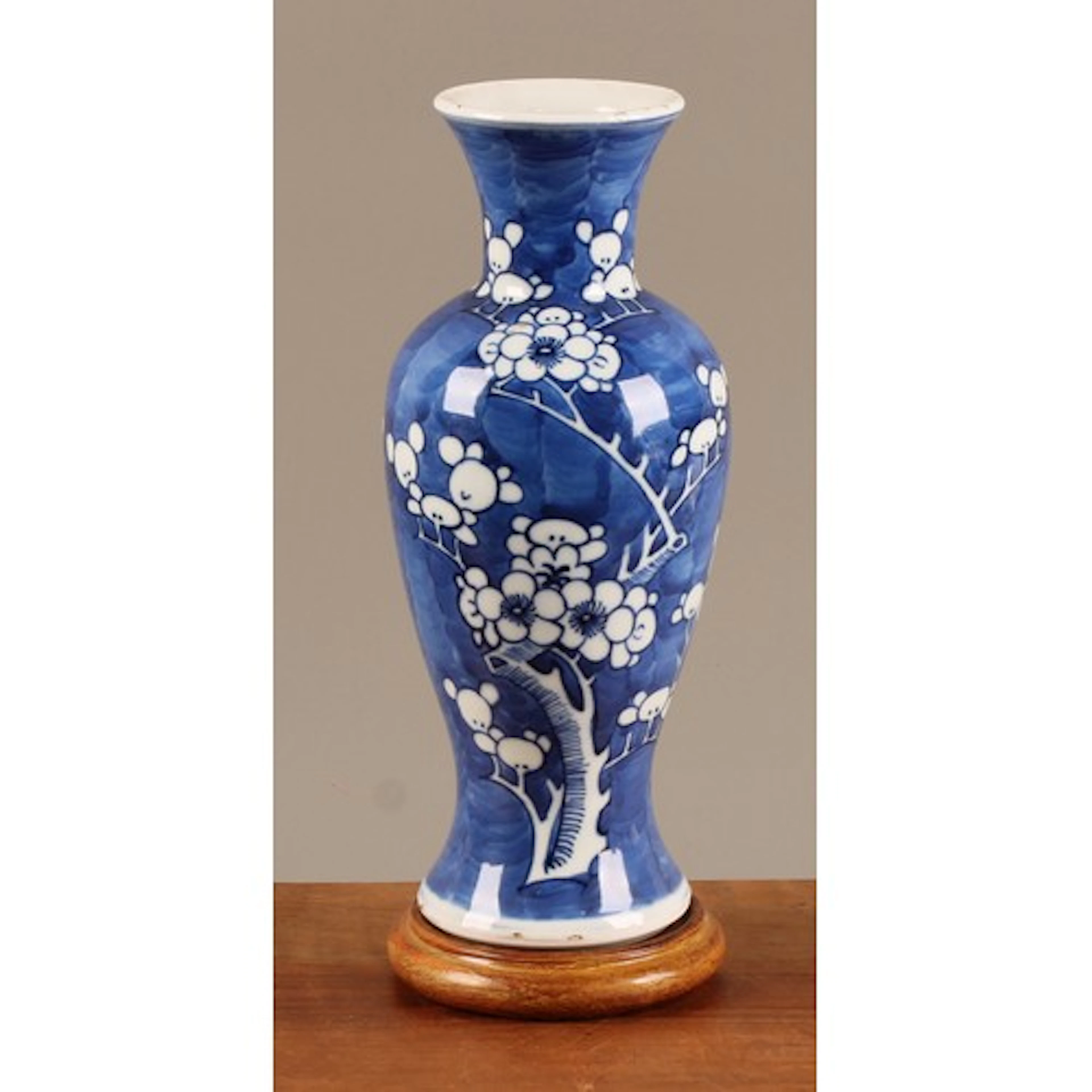 A Chinese slender ovoid vase, painted in tones of underglaze...