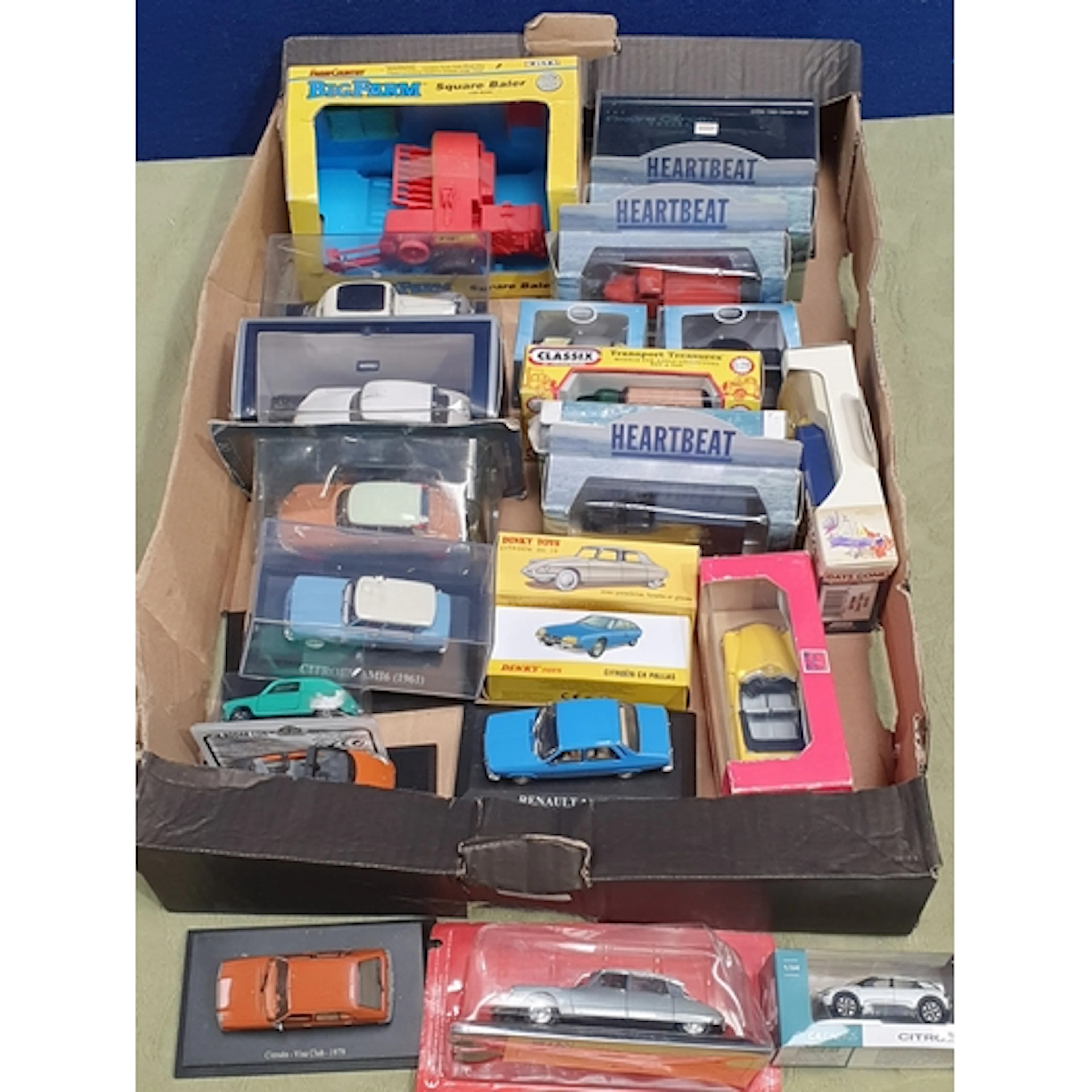 A box of boxed diecast Vehicles including ERTL Bug Farm Bale...