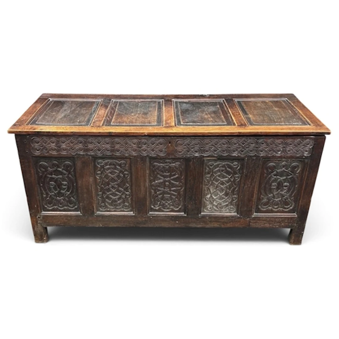 A 17TH/18TH CENTURY OAK COFFER With carved panel front. Left...