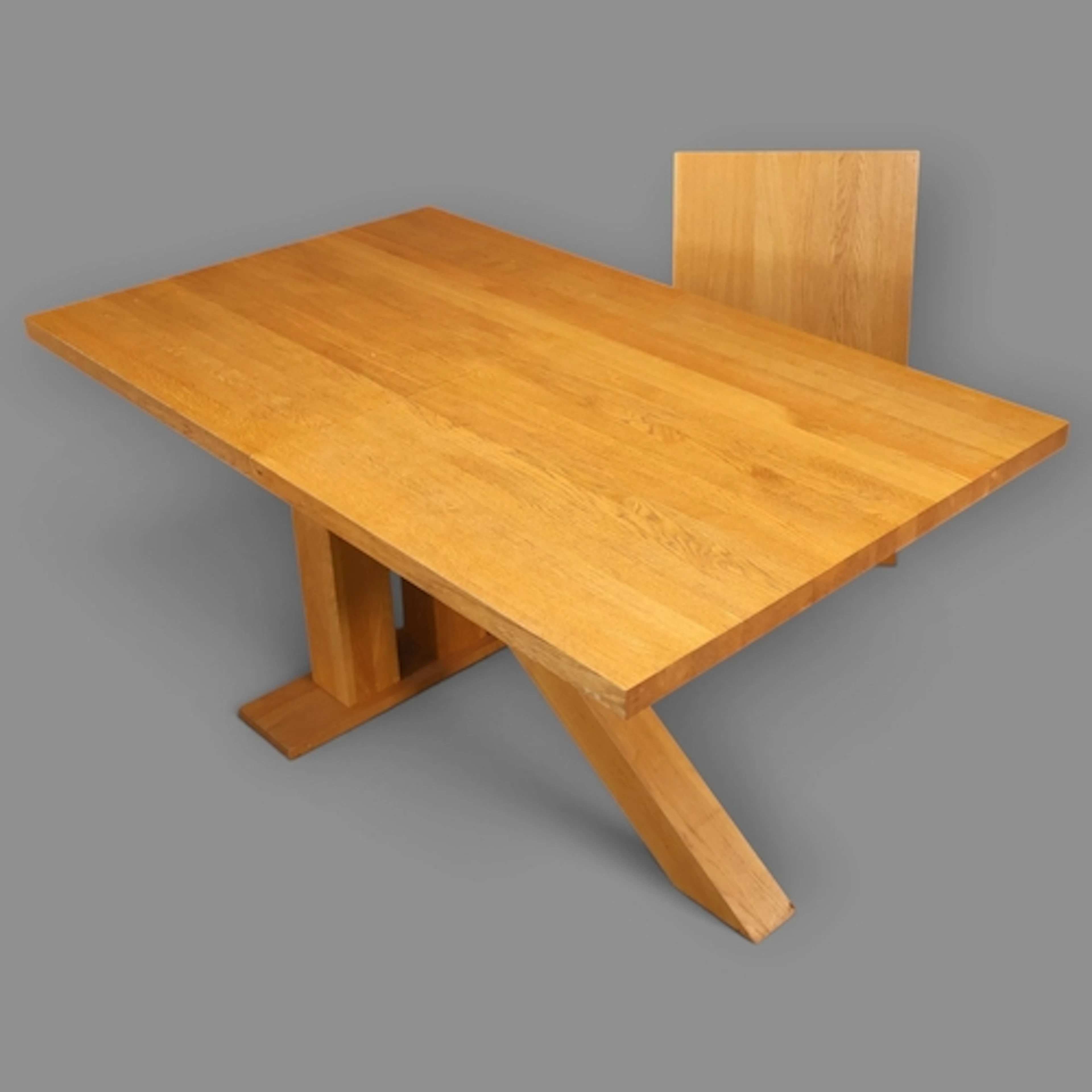 A contemporary light oak draw-leaf dining table, with single...