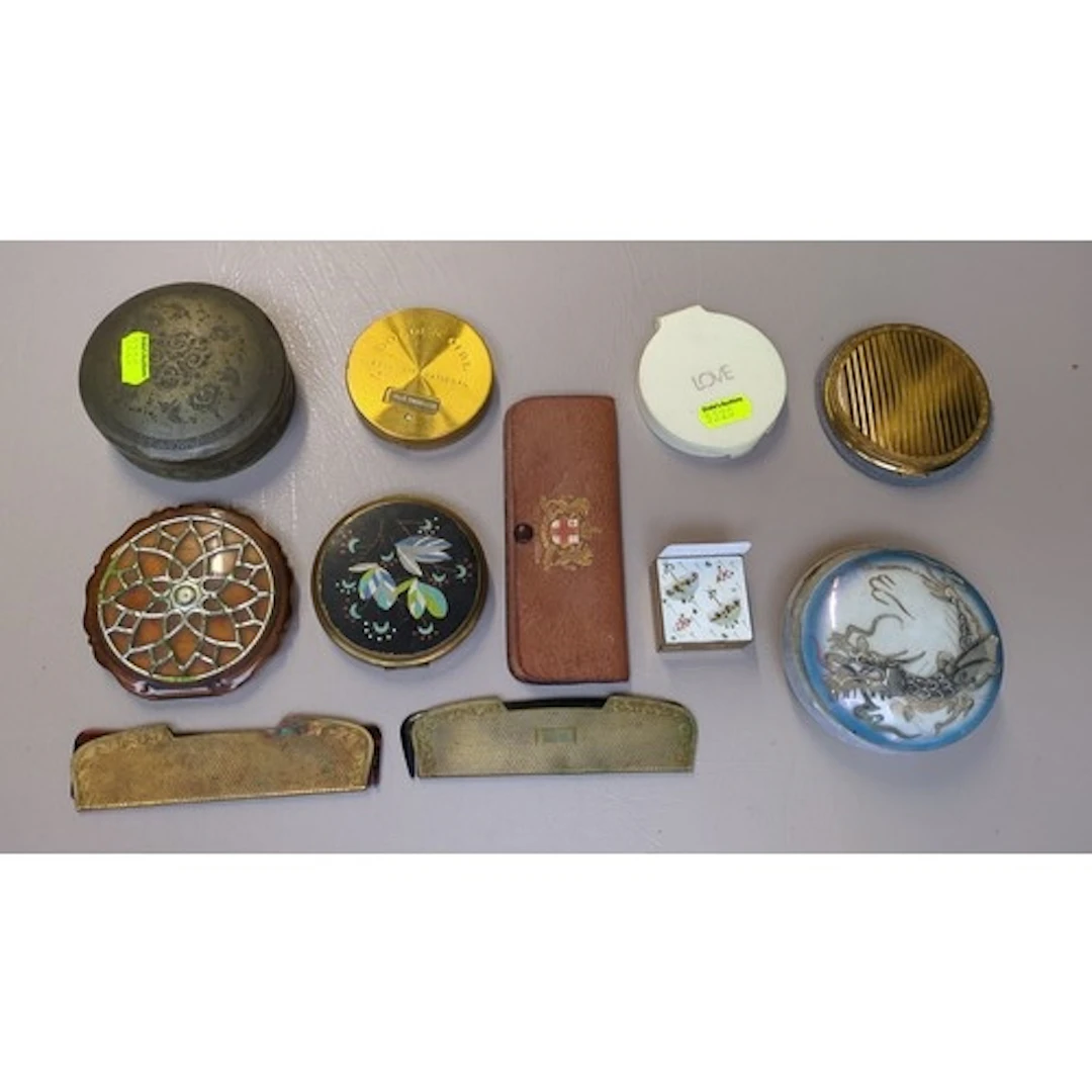 A collection of vintage vanity accessories including mirrore...
