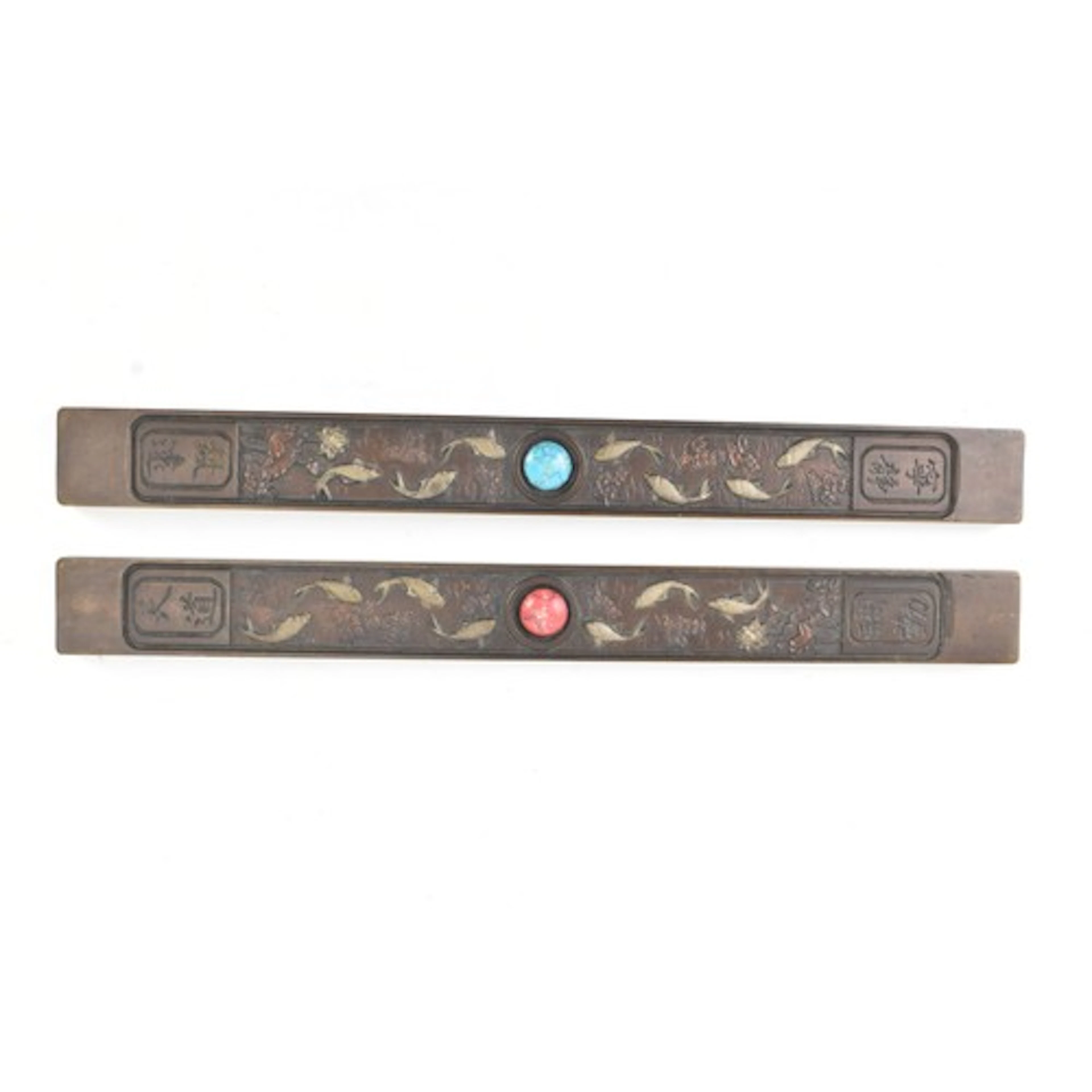 A pair of Chinese copper scholar’s paperweights, of elongate...