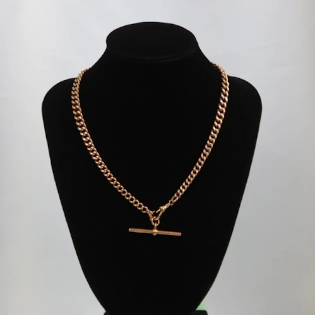 A 20th century 9ct gold watch chain, the graduated curb link...