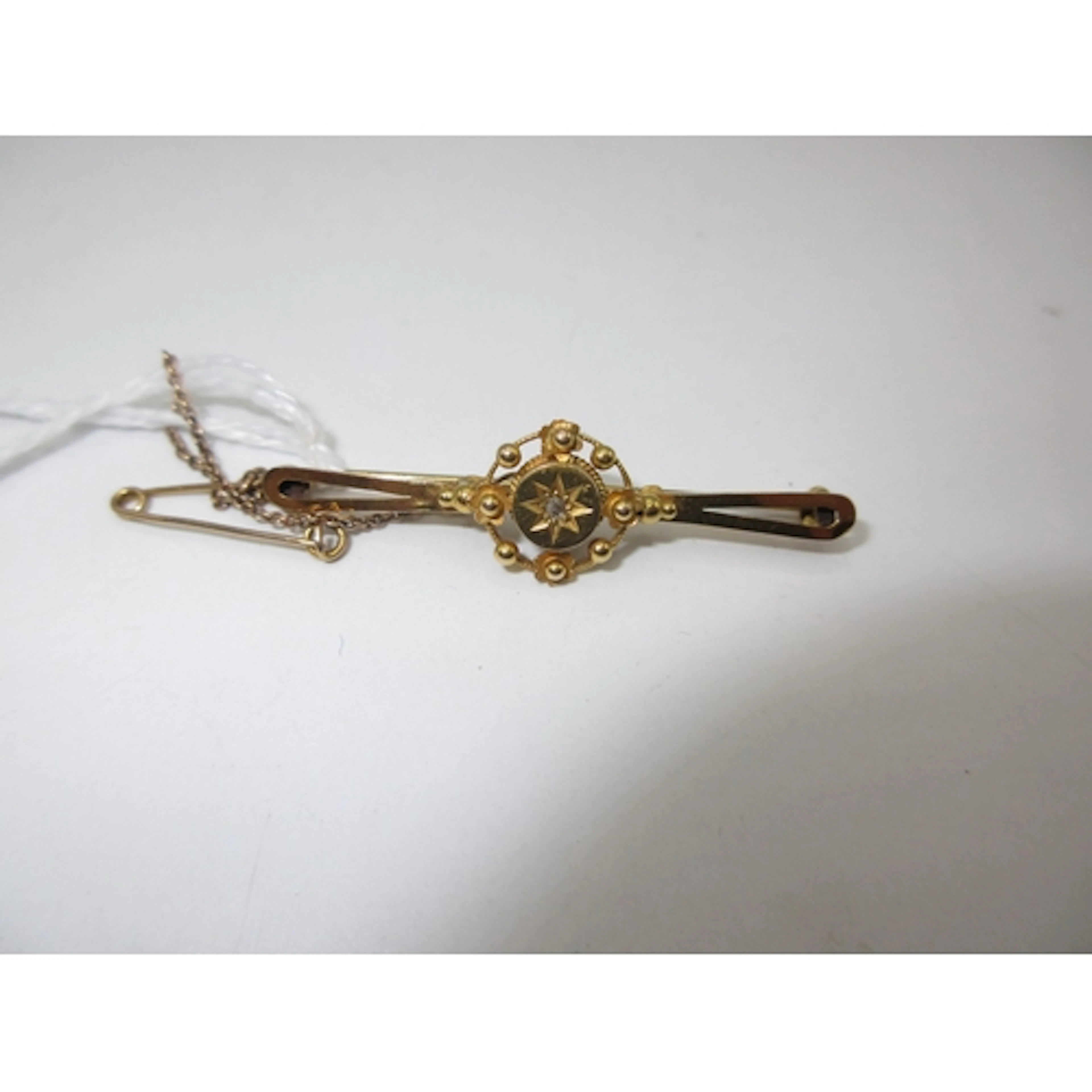 Gold Bar Brooch Set with a Small Rose Cut Diamond in Unmarke...