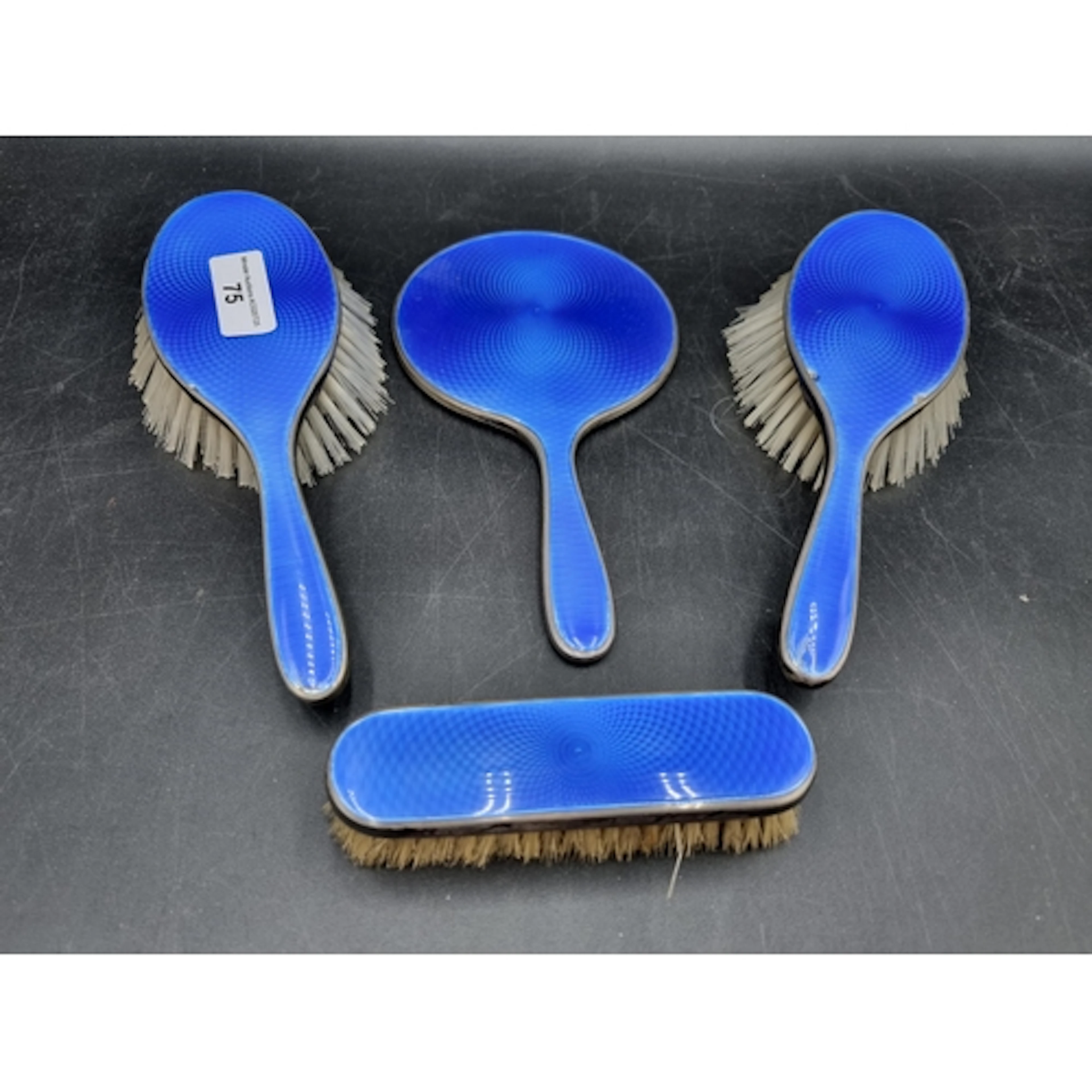 A George V silver and blue basse taille enamel four piece Dr...
