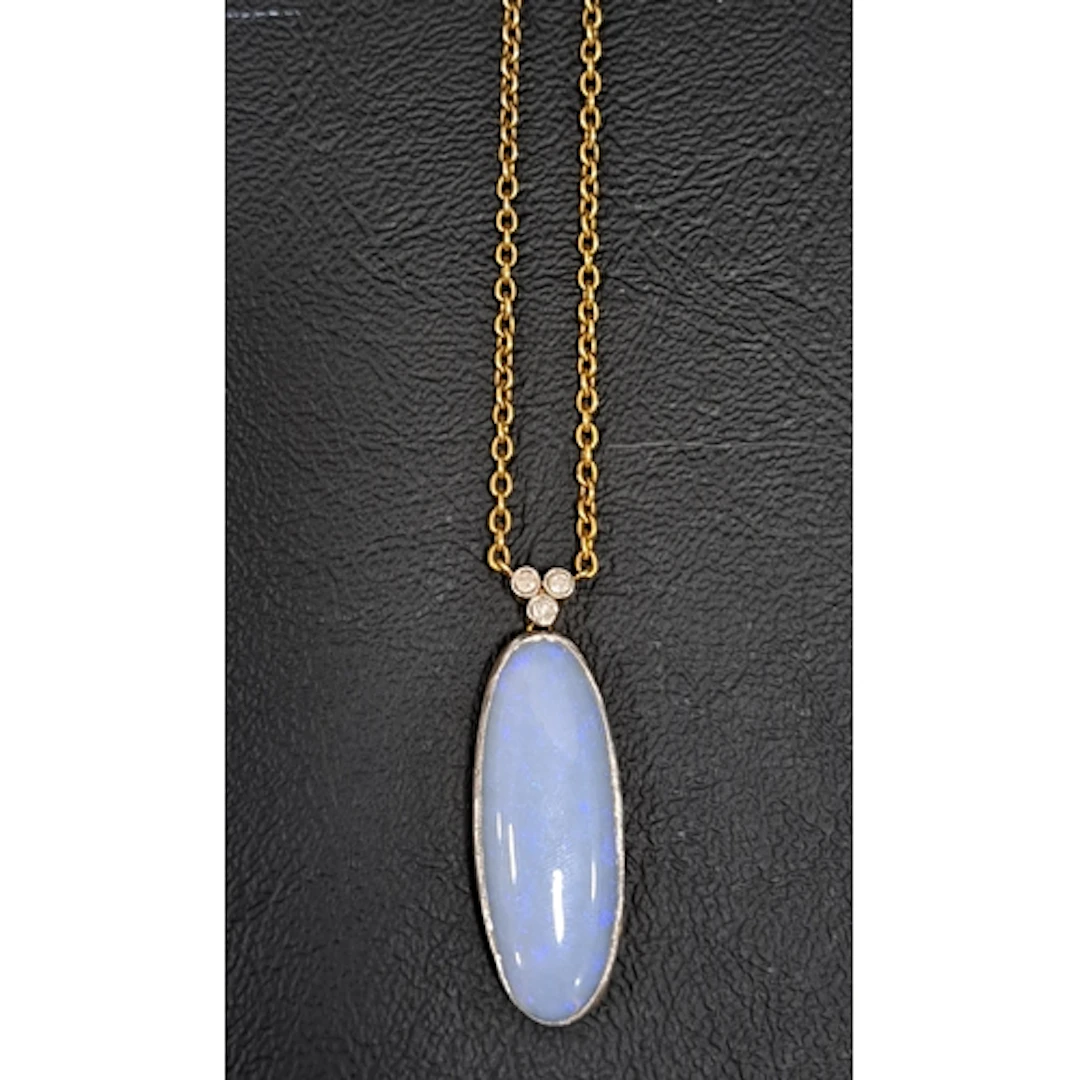 OPAL AND DIAMOND PENDANT the oval cabochon opal approximatel...