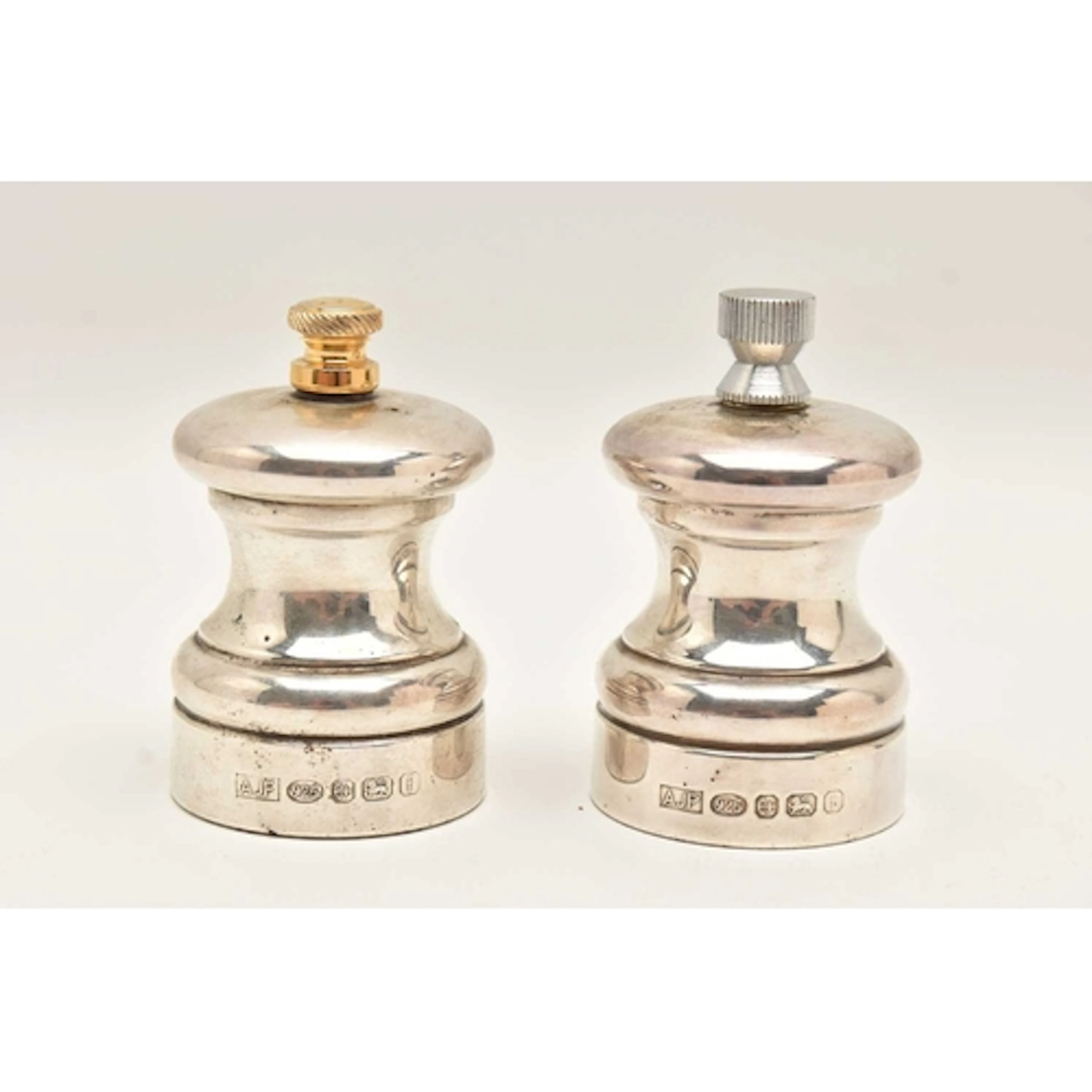 A PAIR OF SILVER SALT AND PEPPER MILLS, hallmarked 'A J Pool...