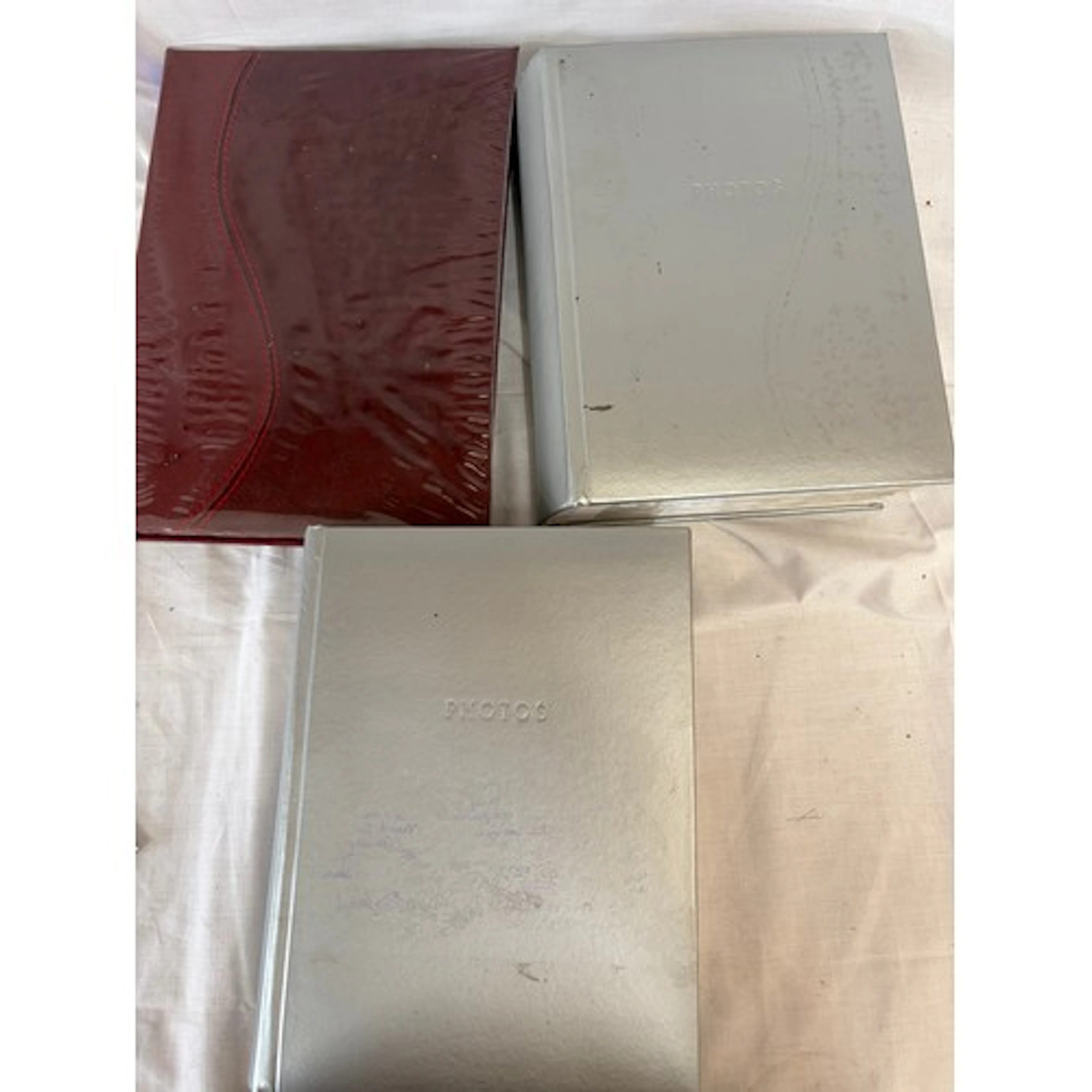 A collection of three postcard albums to include real photos...