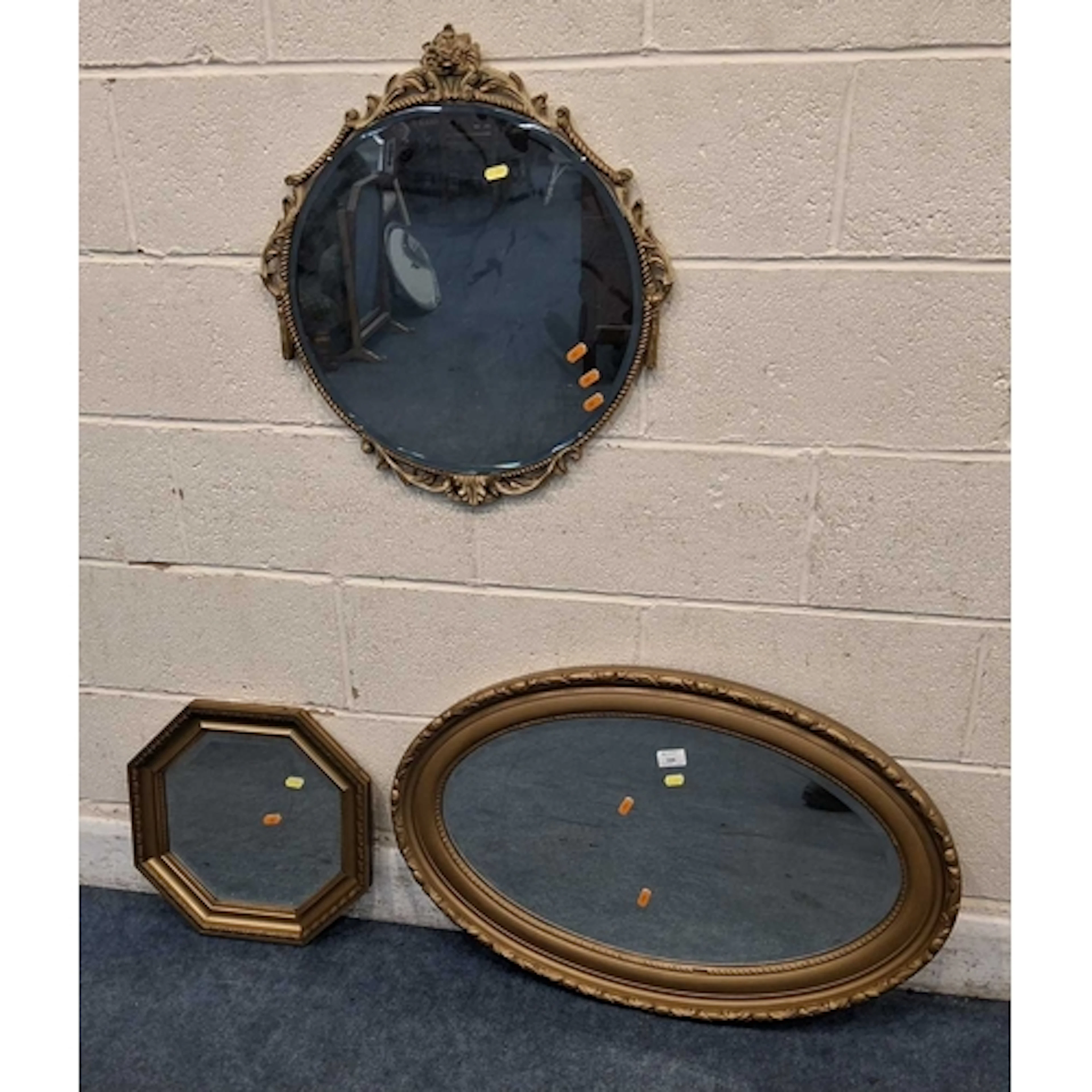 THREE GILT FRAMED BEVELED EDGE WALL MIRRORS, varying in shap...
