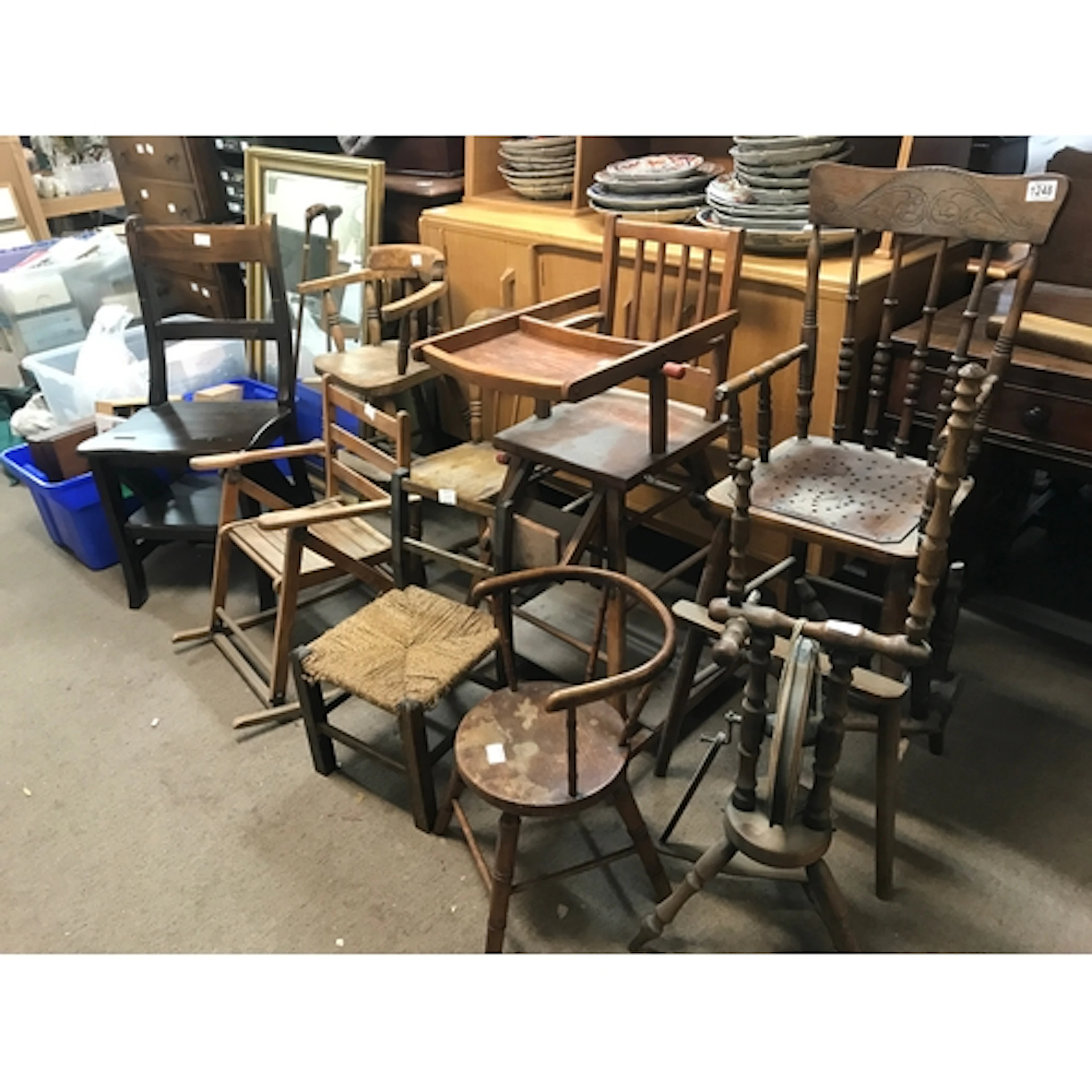 A collection of antique and vintage wooden children's chairs...