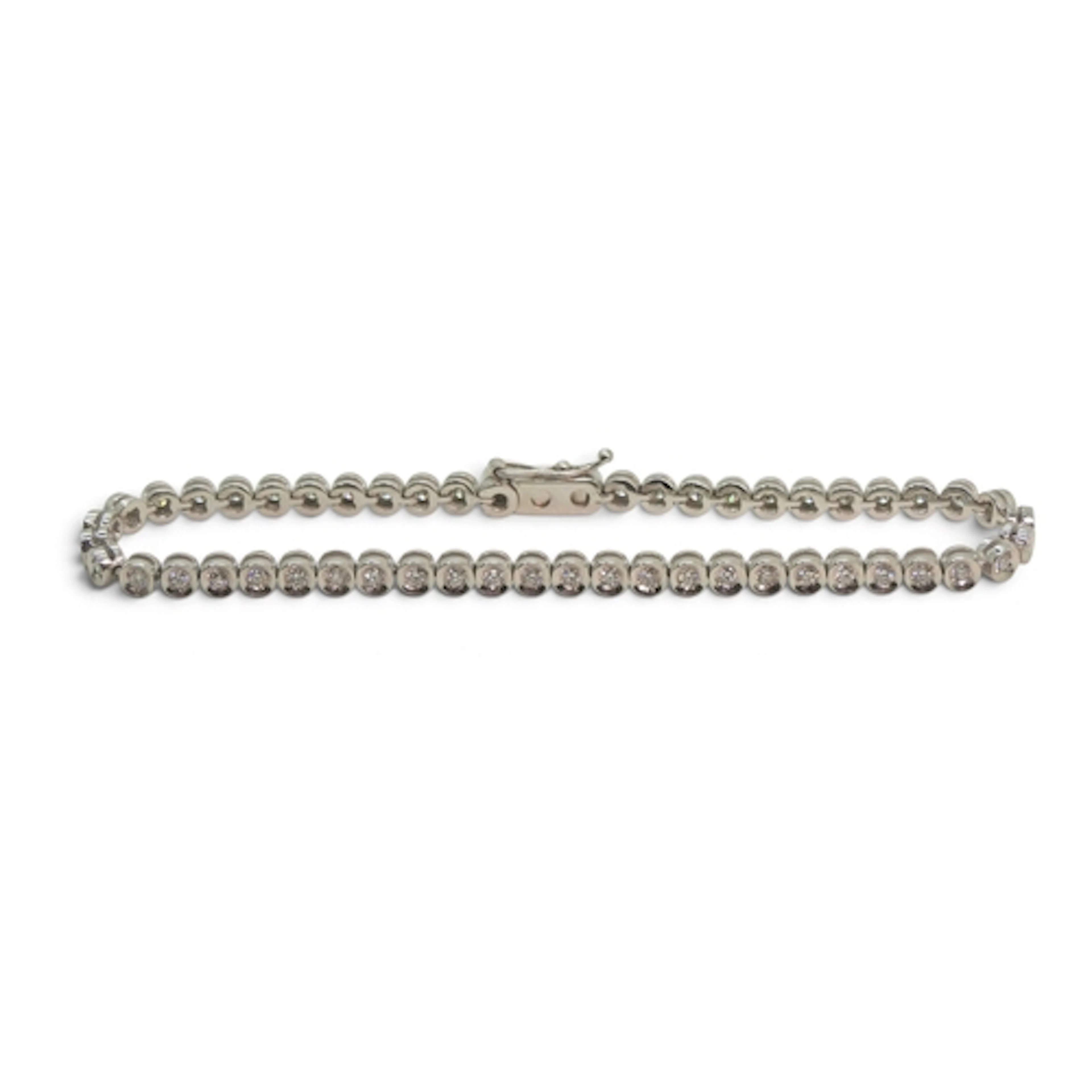 An 18ct gold diamond line bracelet set with estimated approx...