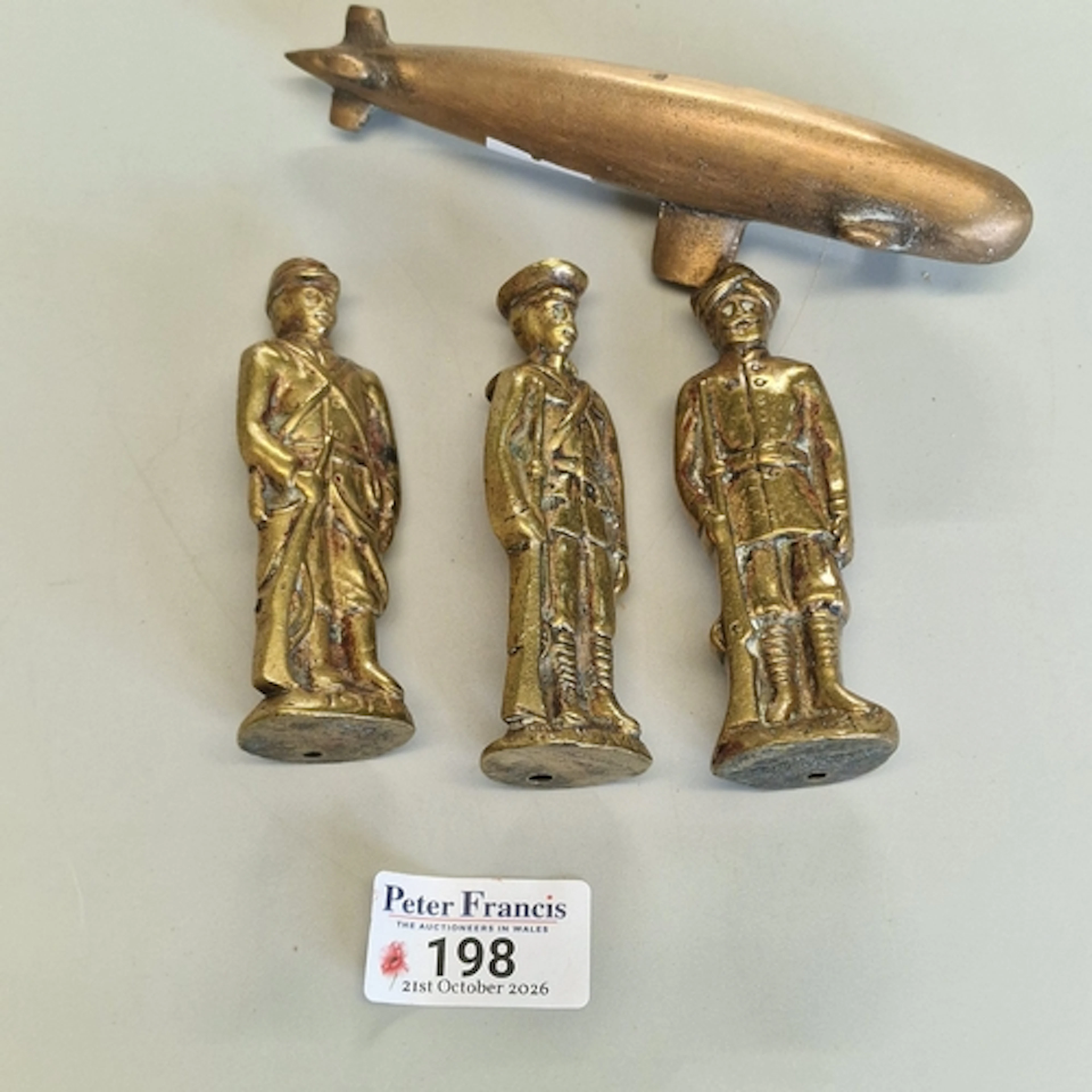 Trench art, comprising three WW1 brass soldier figures, each...