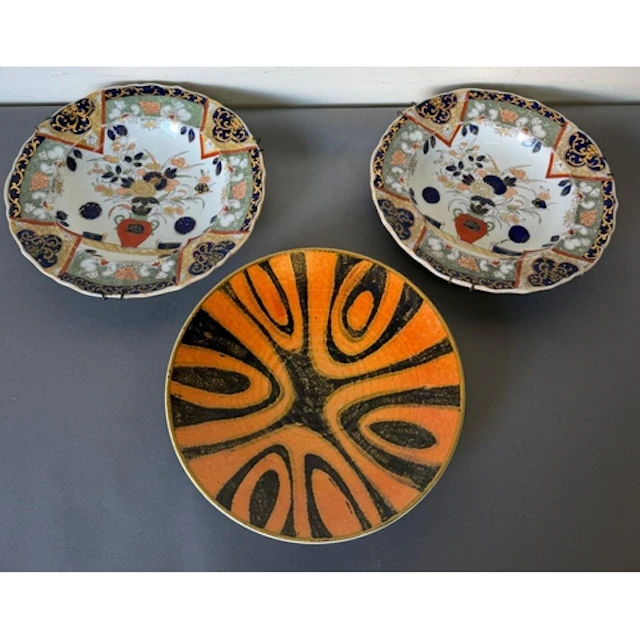 A pair of porcelian charger plates along with a decortive Po...