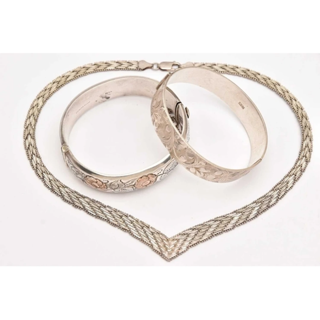 TWO SILVER BANGLES AND A NECKLACE, two hinged bangles with f...