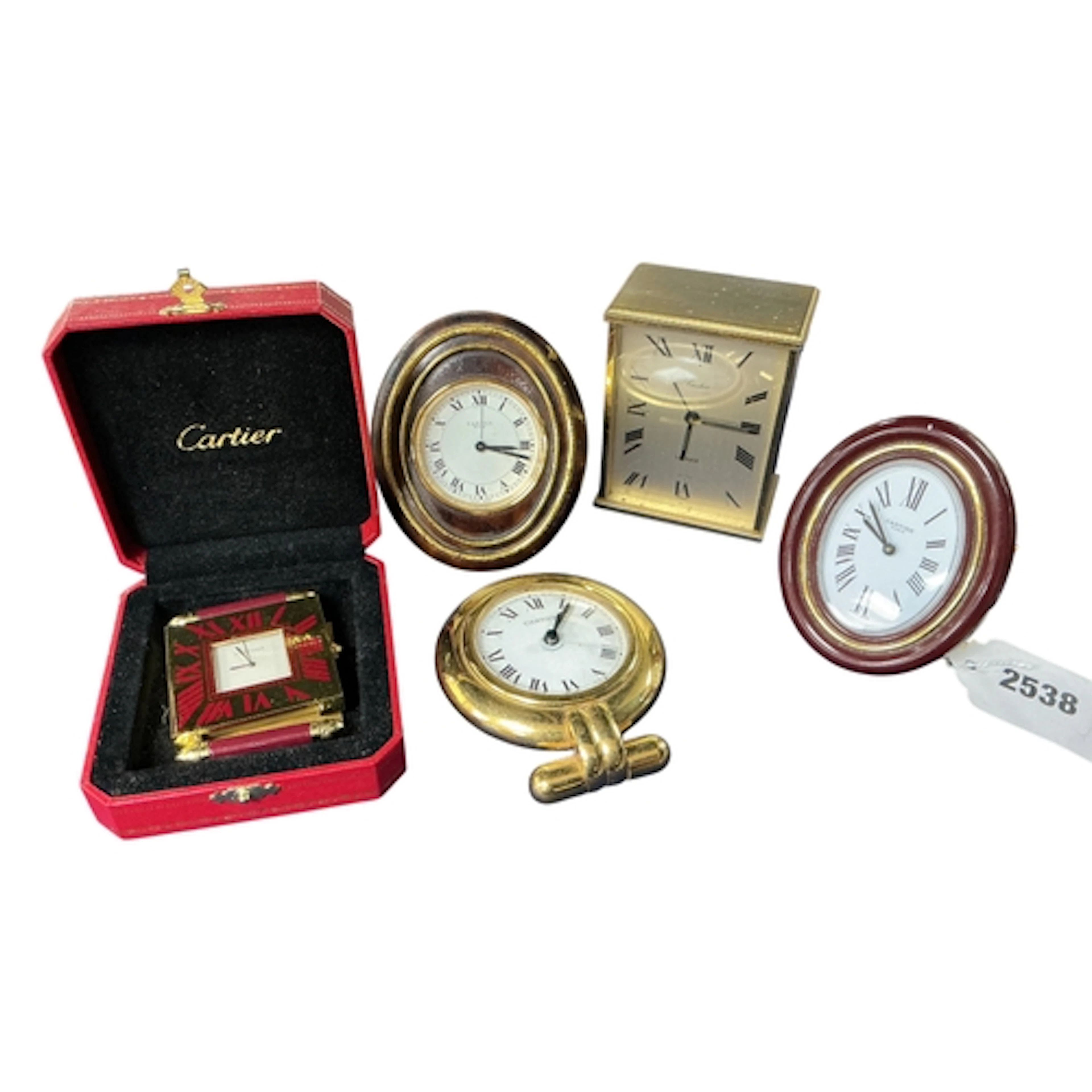 A collection of five Cartier clocks, comprising a Baignoire ...
