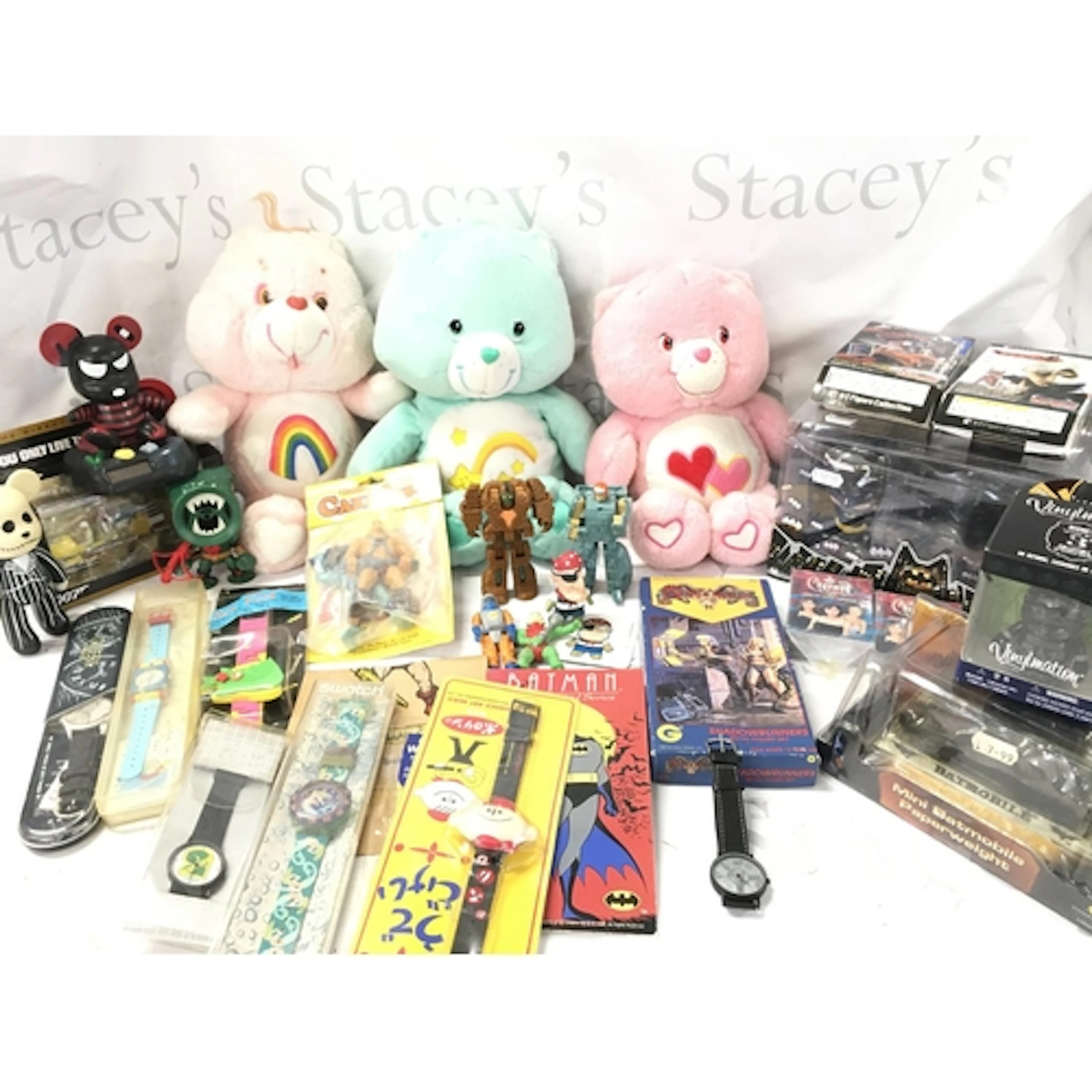 A Collection of Care Bears. Batman. Rock lords. Watches. Cha...