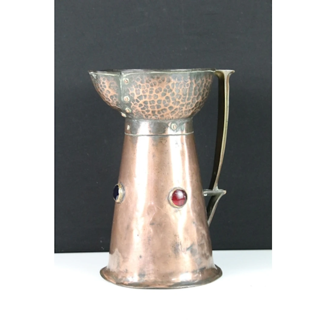 Arts & Crafts copper and brass jug, with flared planished ri...