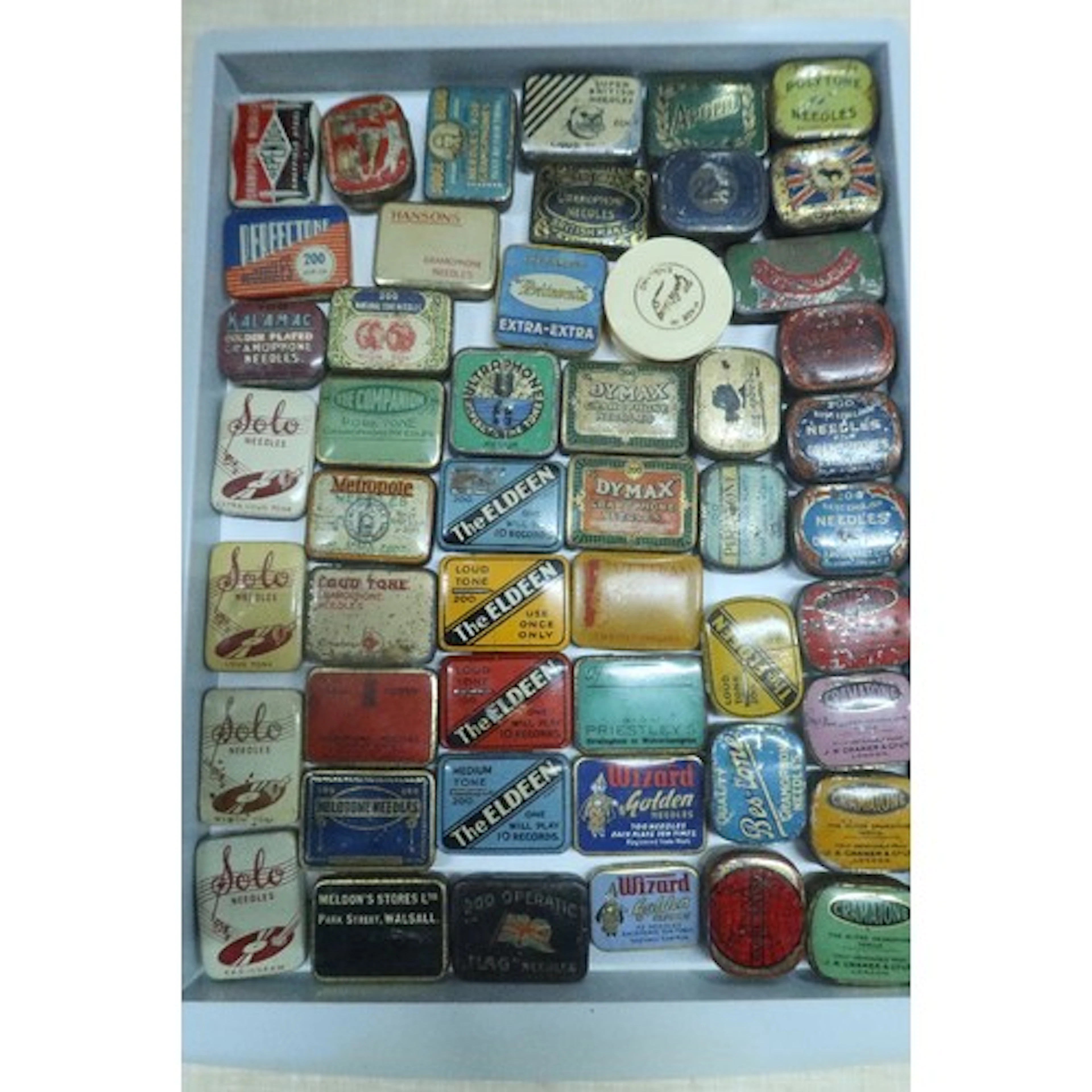 A tray of vintage gramphone needle tins