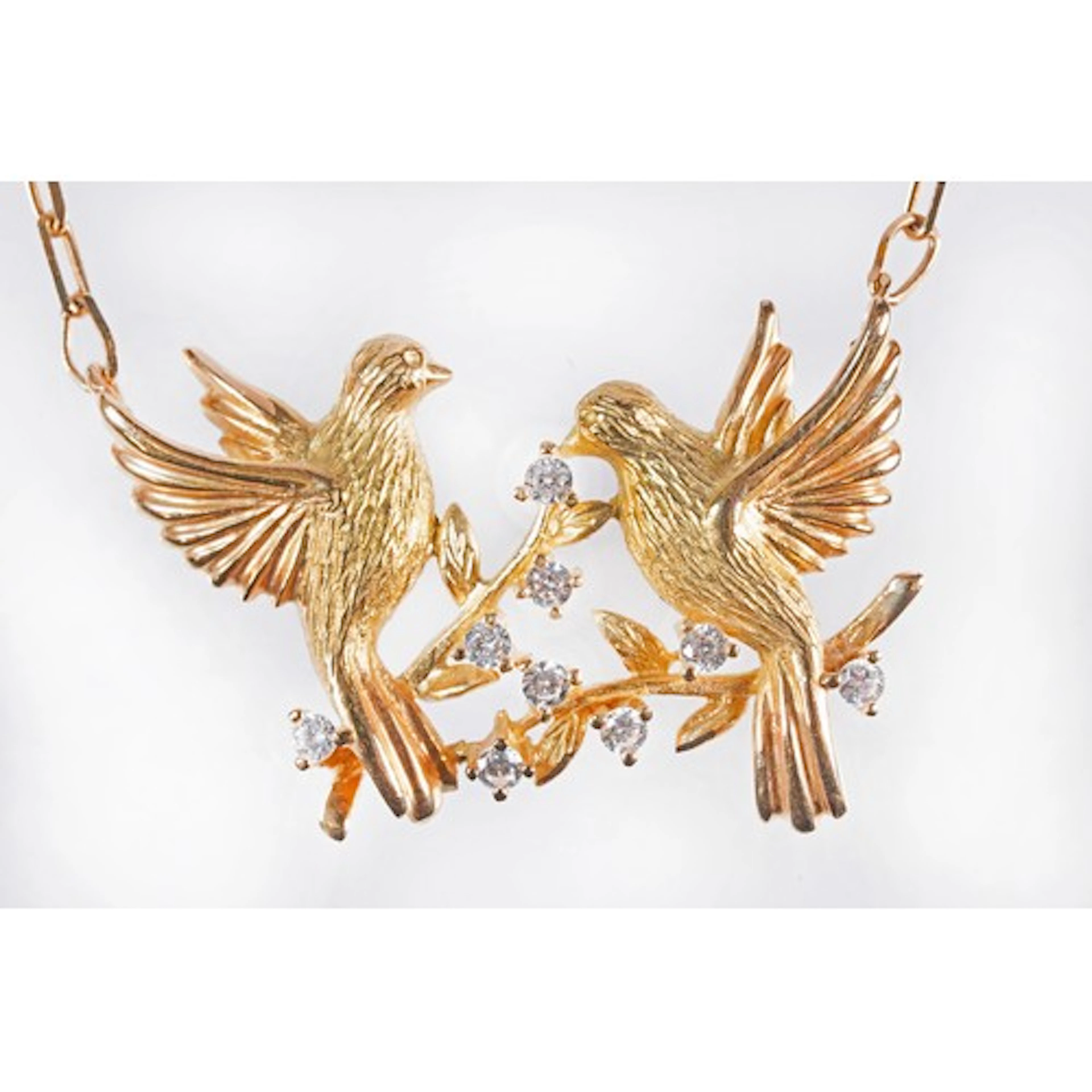 18ct gold and diamond bird pendant necklace featuring two pe...
