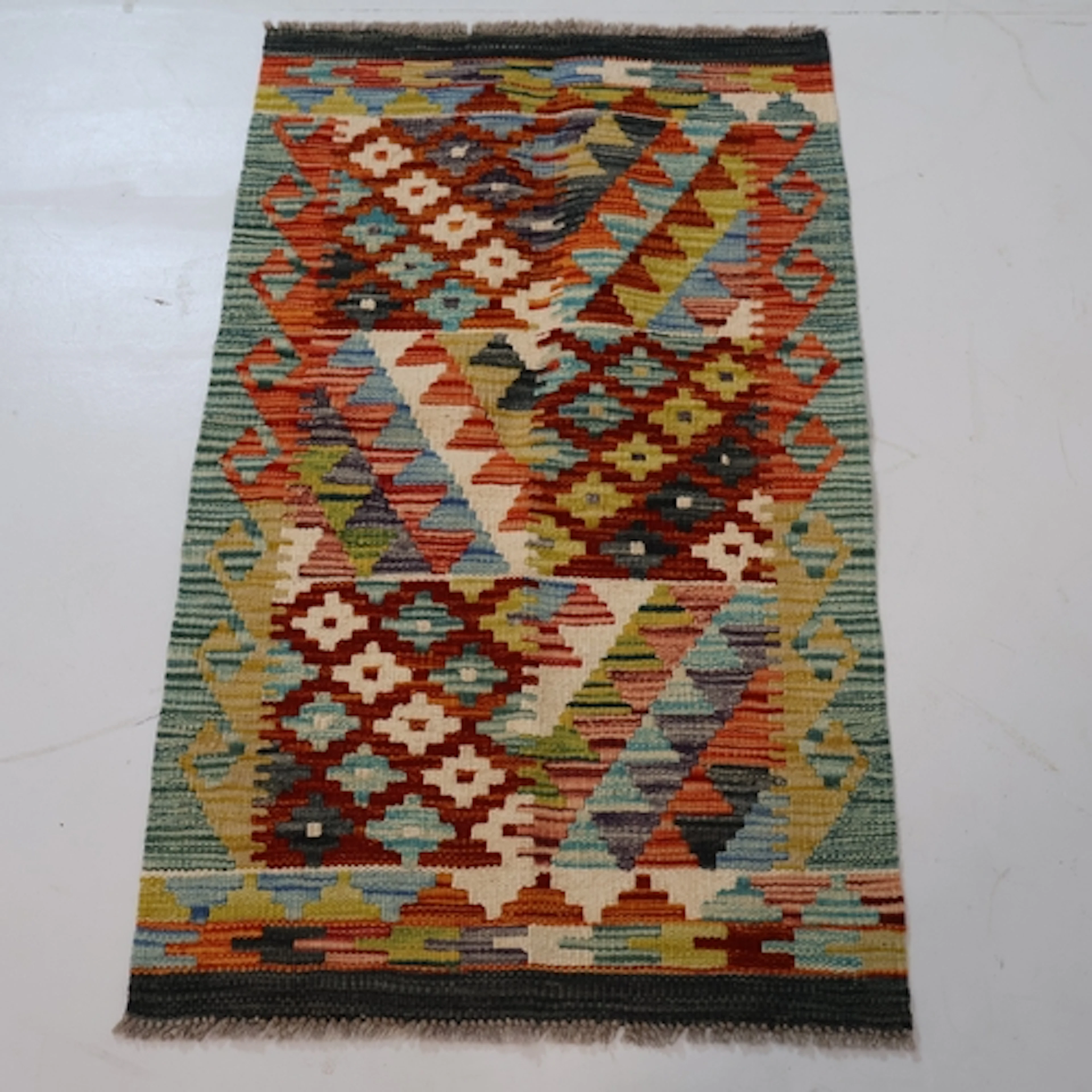 A small multi-coloured chobi kilim rug, L94cm, W58cm.