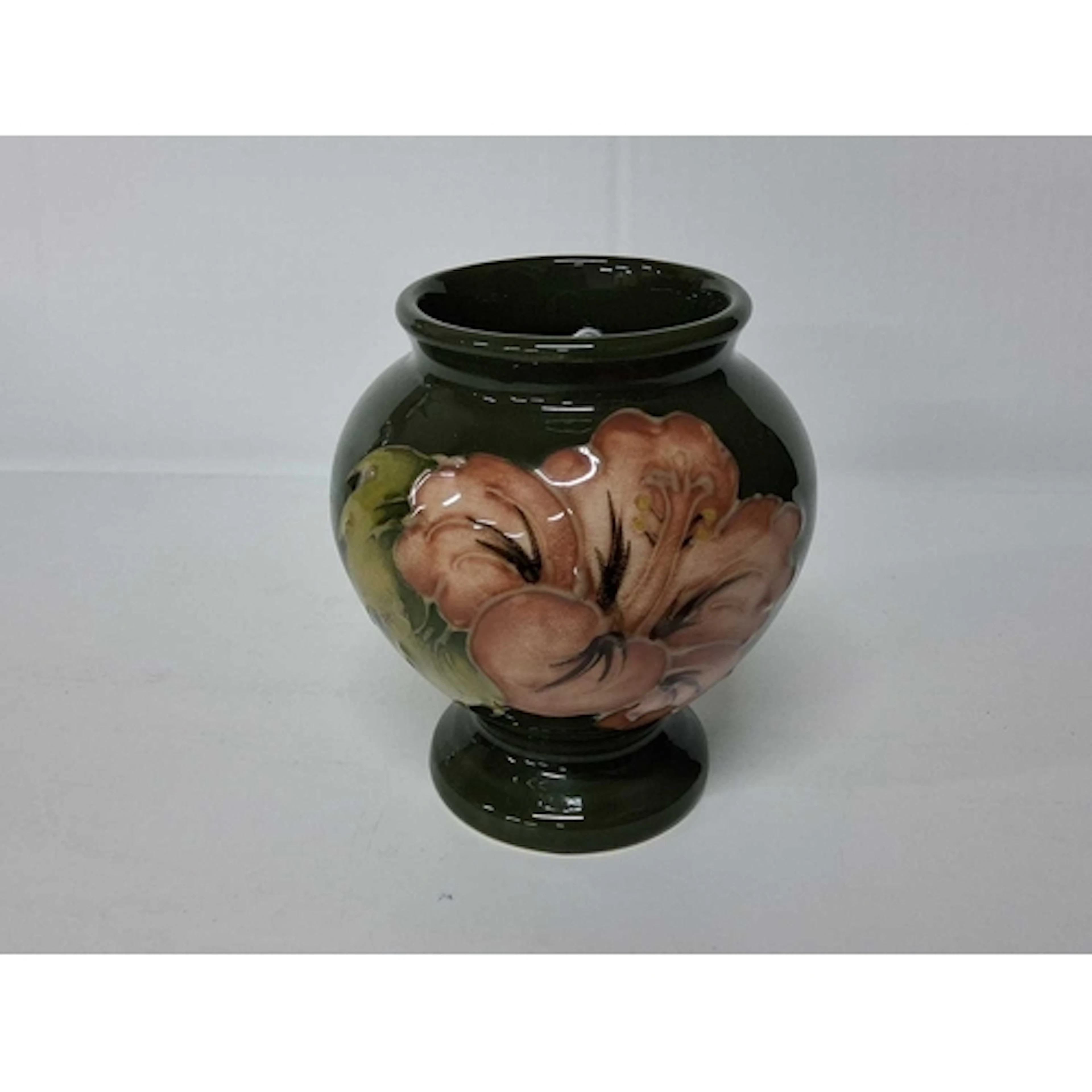A MOORCROFT POTTERY CORAL HIBISCUS URN VASE, tube-lined with...