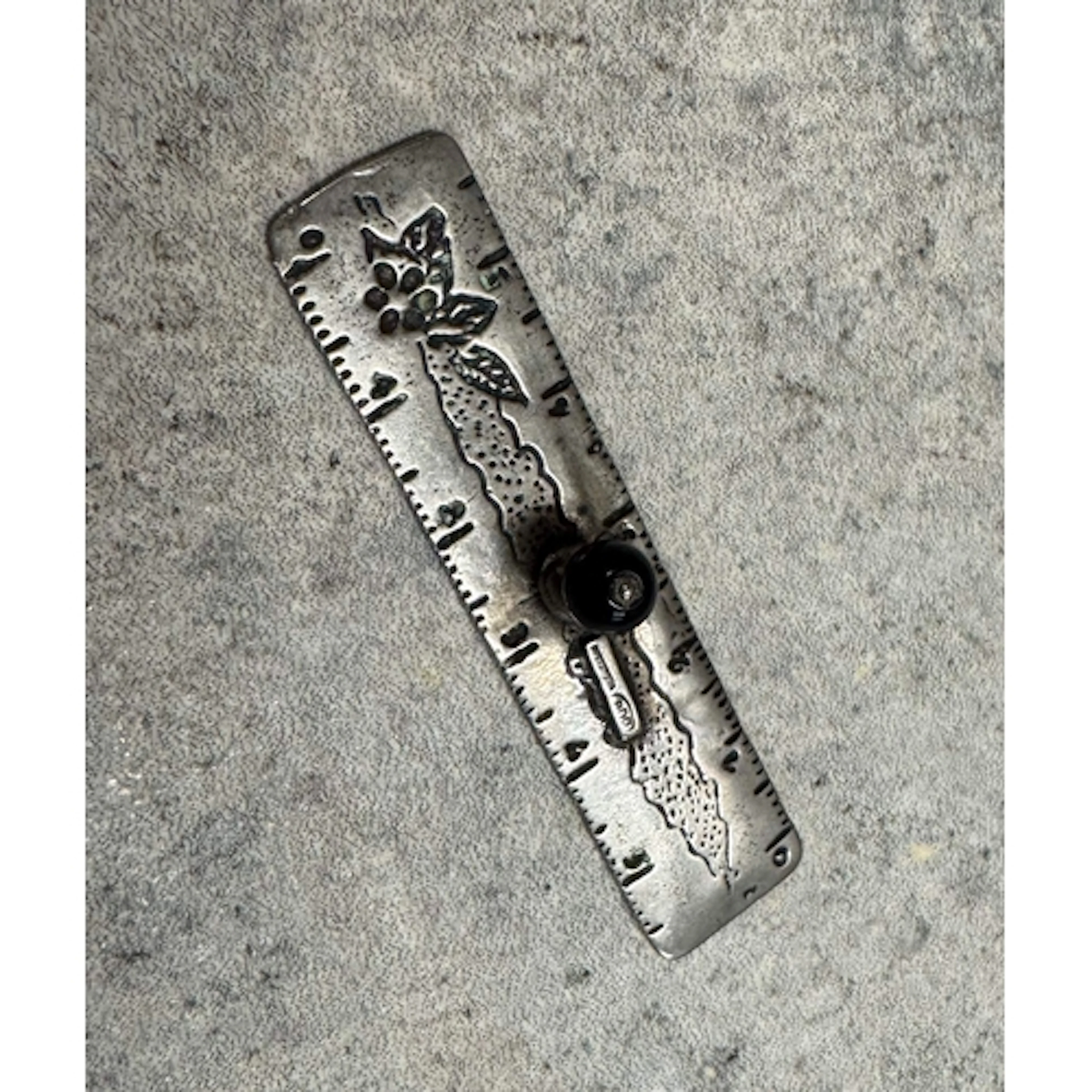 A silver toy ruler. Approx. 5 grams. Est. £20 - £30.