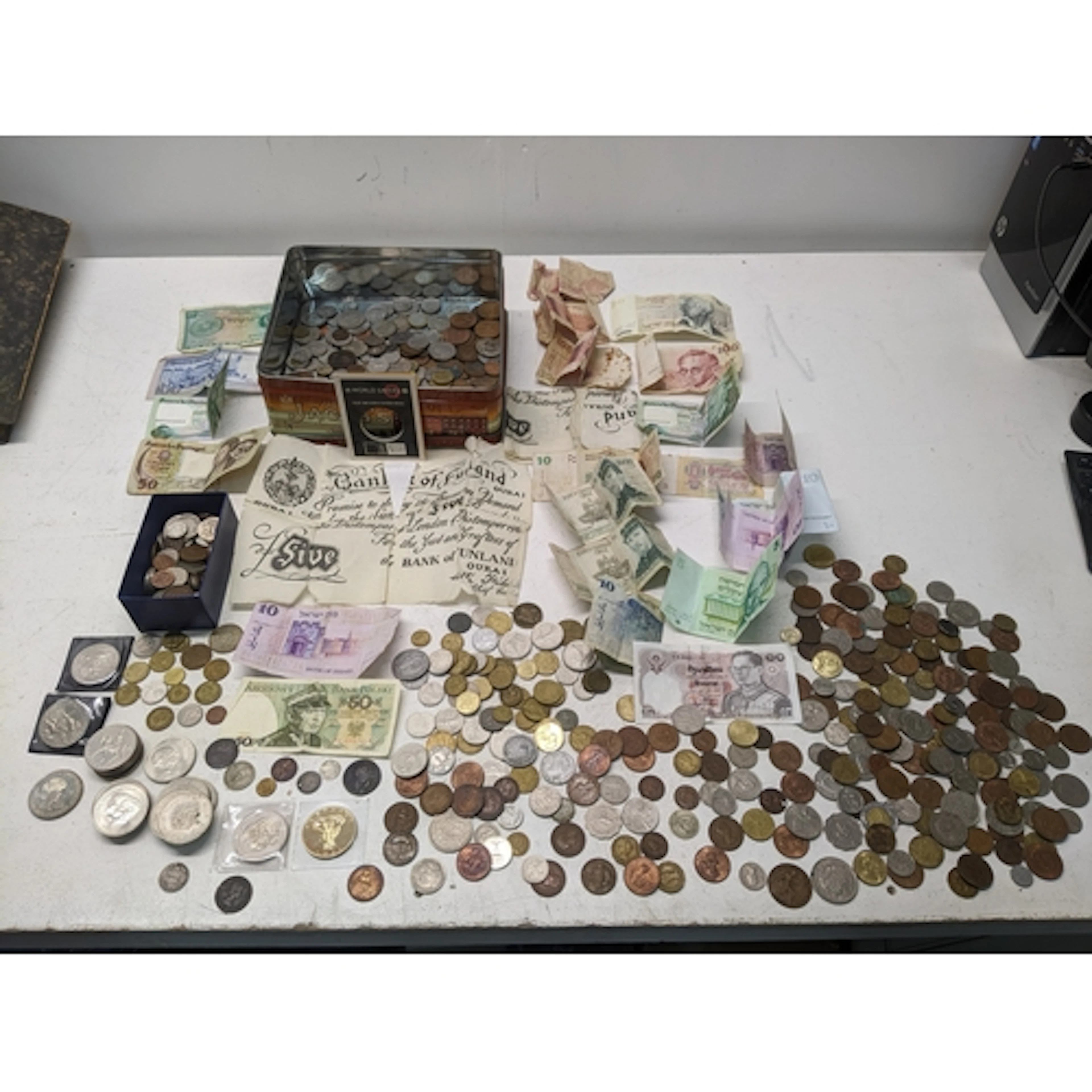 A quantity of mixed banknotes and coinage from various world...