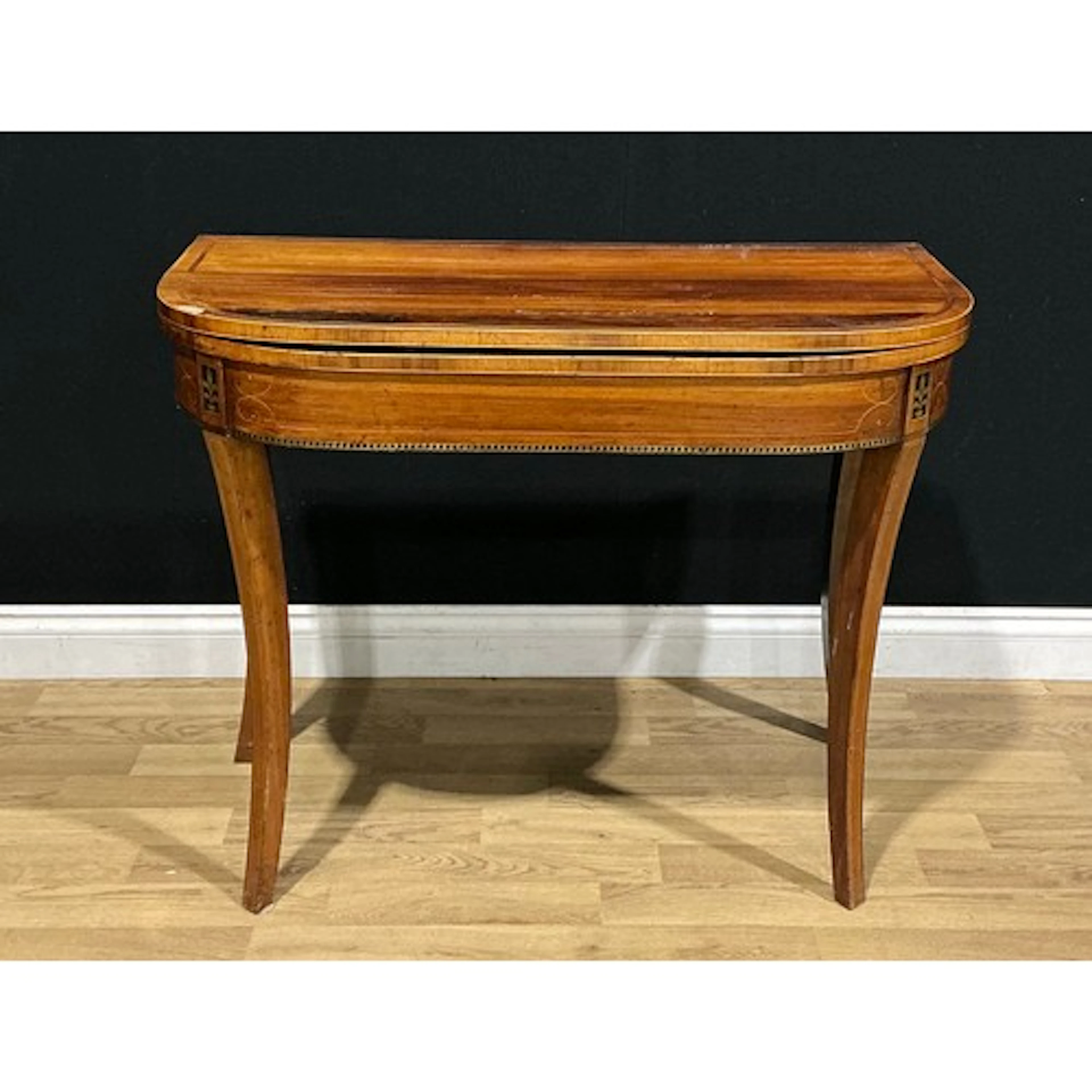 A Regency rosewood card table, hinged top enclosing a baize ...
