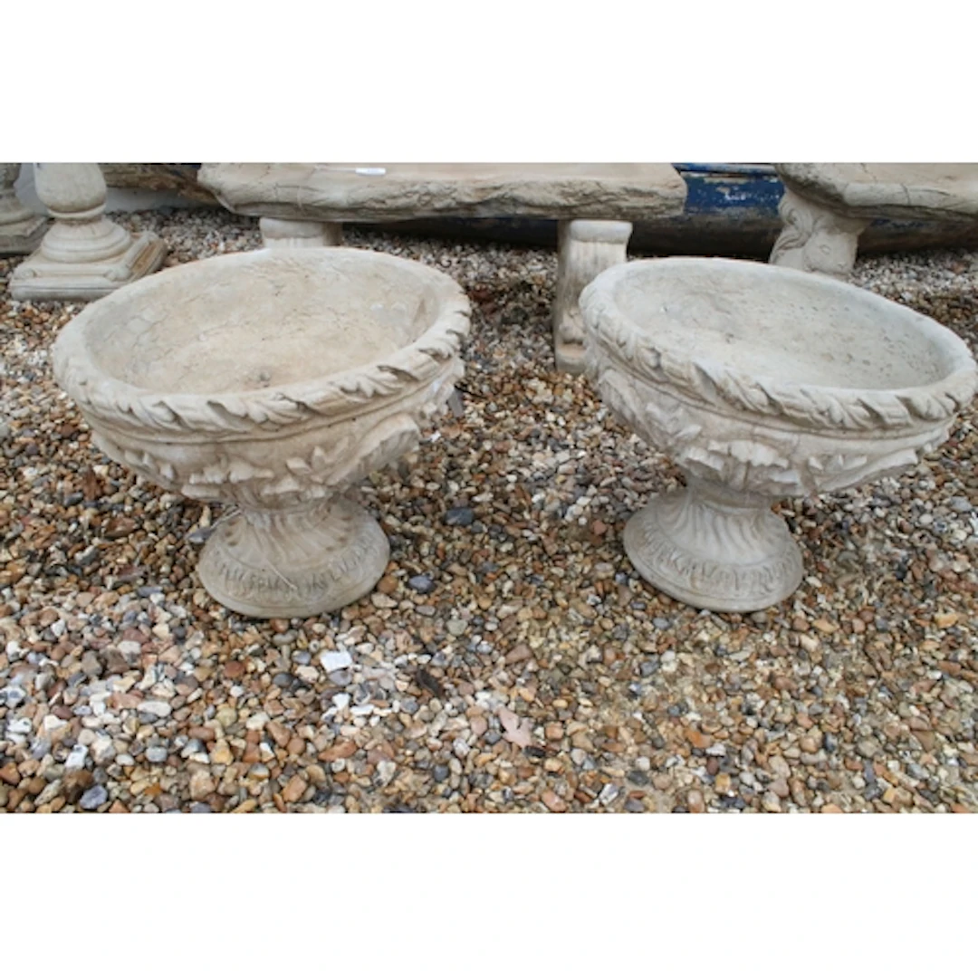 Pair of reconstituted stone garden urns, decorated with acan...