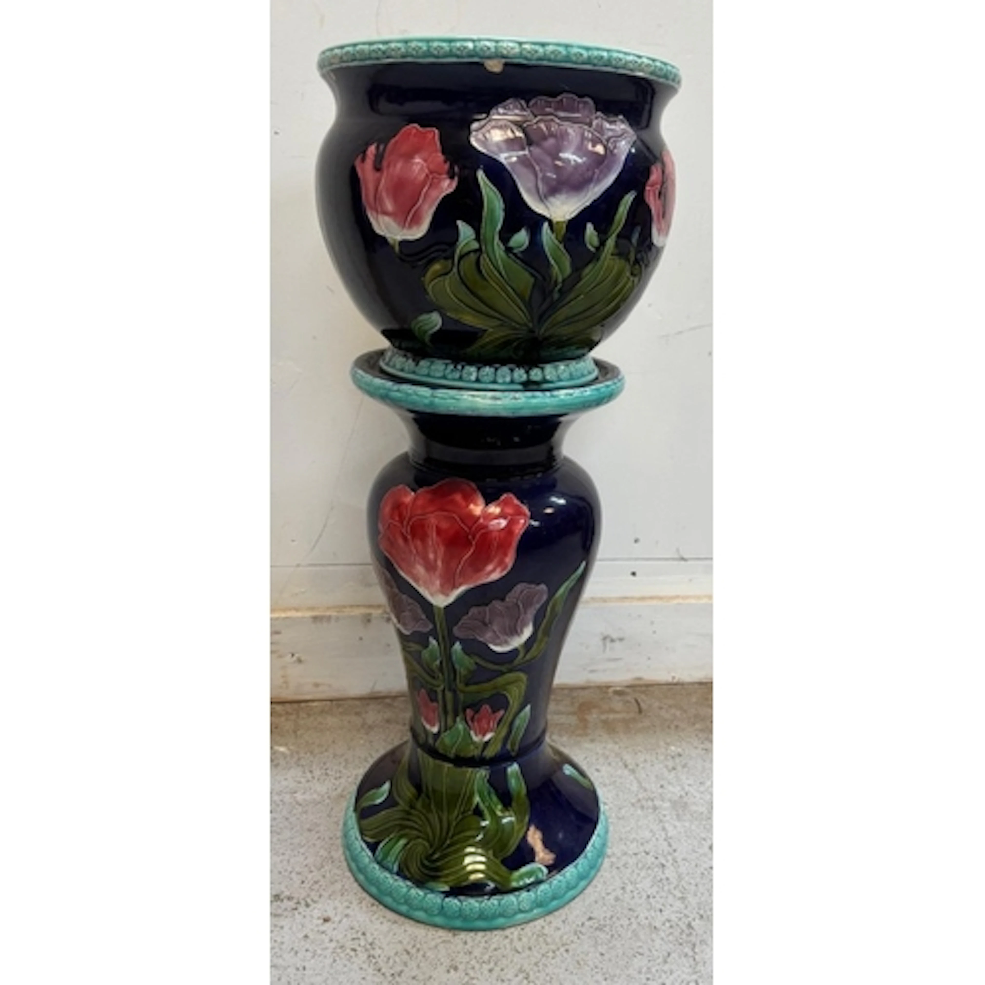 A ceramic jardinière and matching pedestal stand in a deep c...