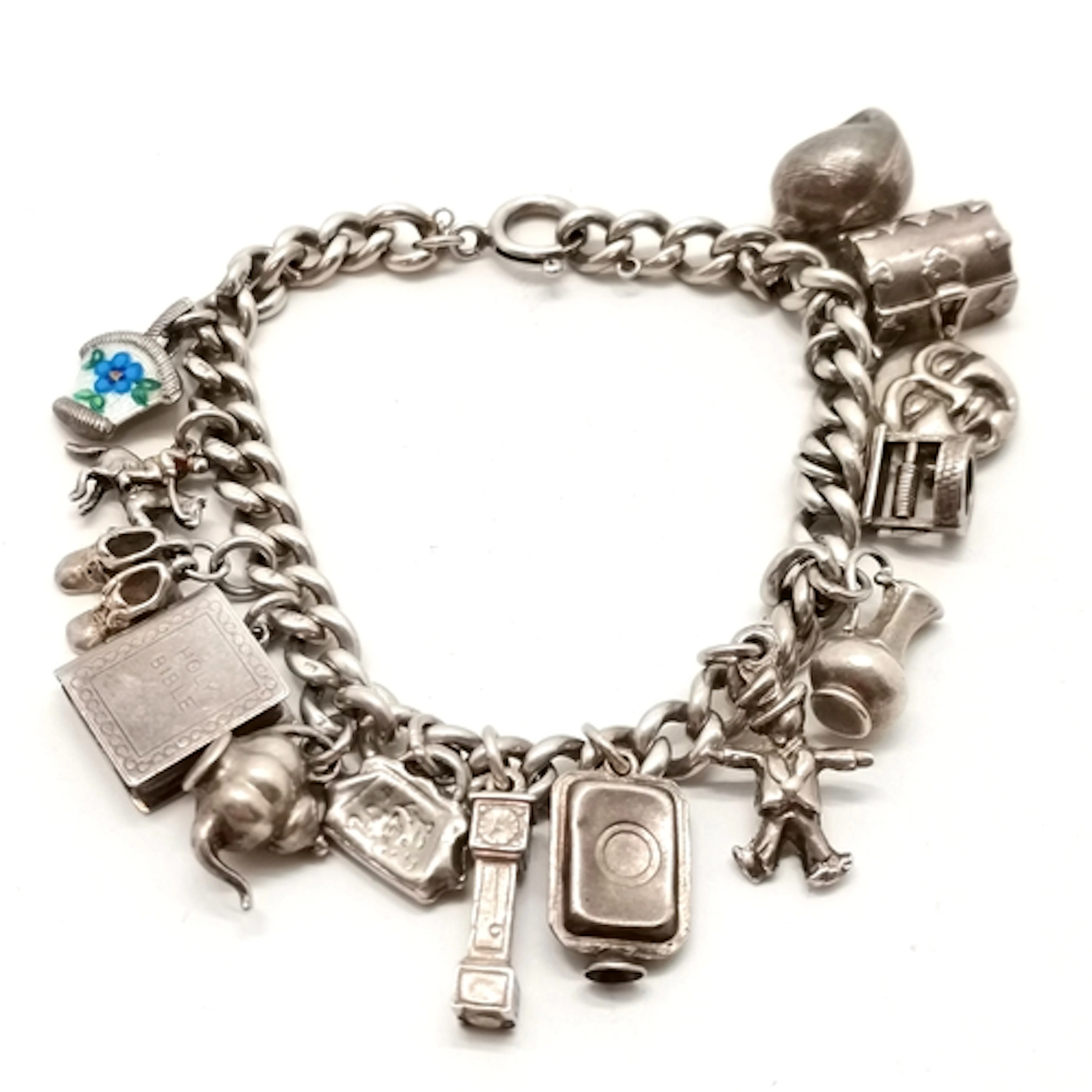 Silver charm bracelet with charms inc holy bible, shell, tre...