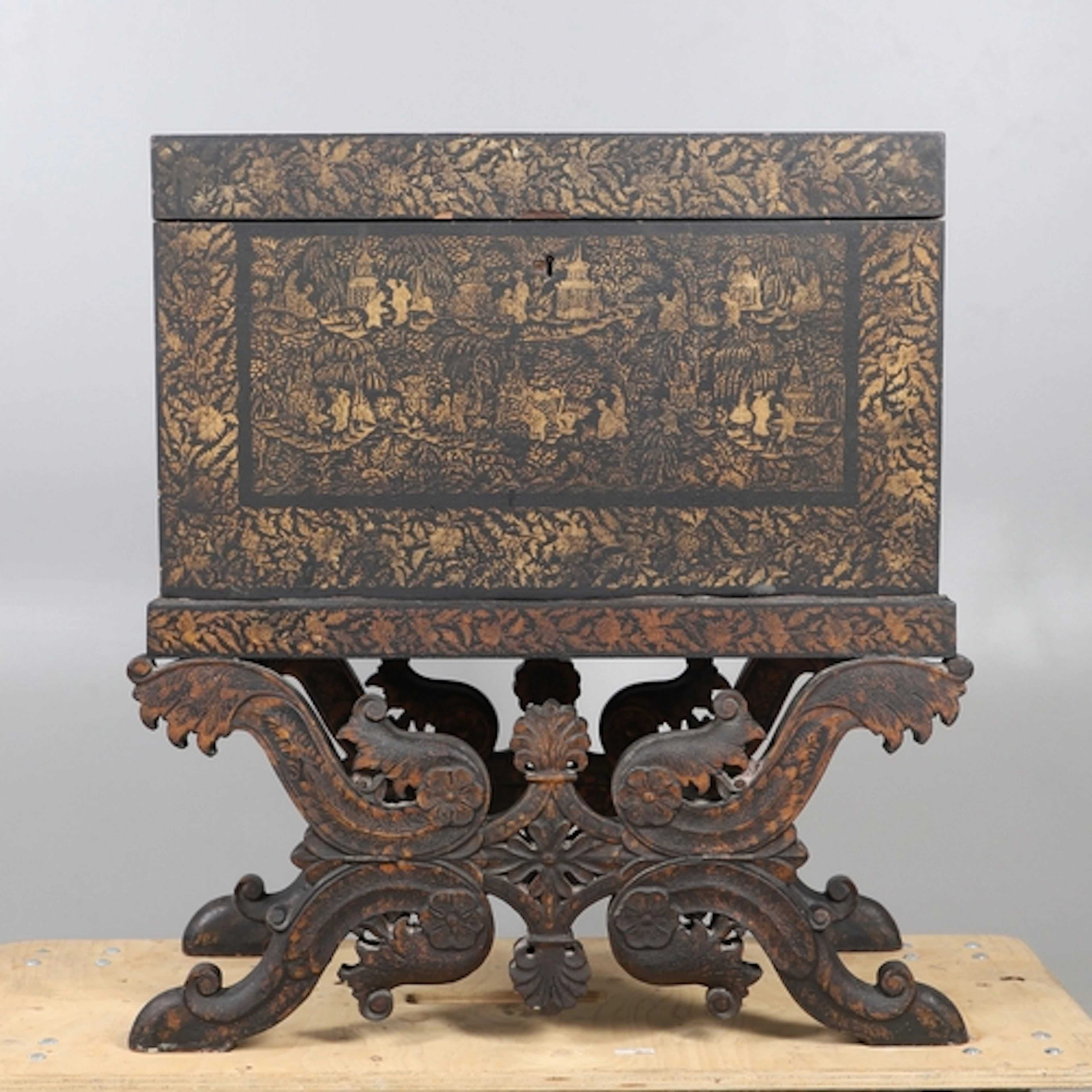 A LACQUERED & GILT CHINOISERIE TRUNK ON STAND, PROBABLY INDI...