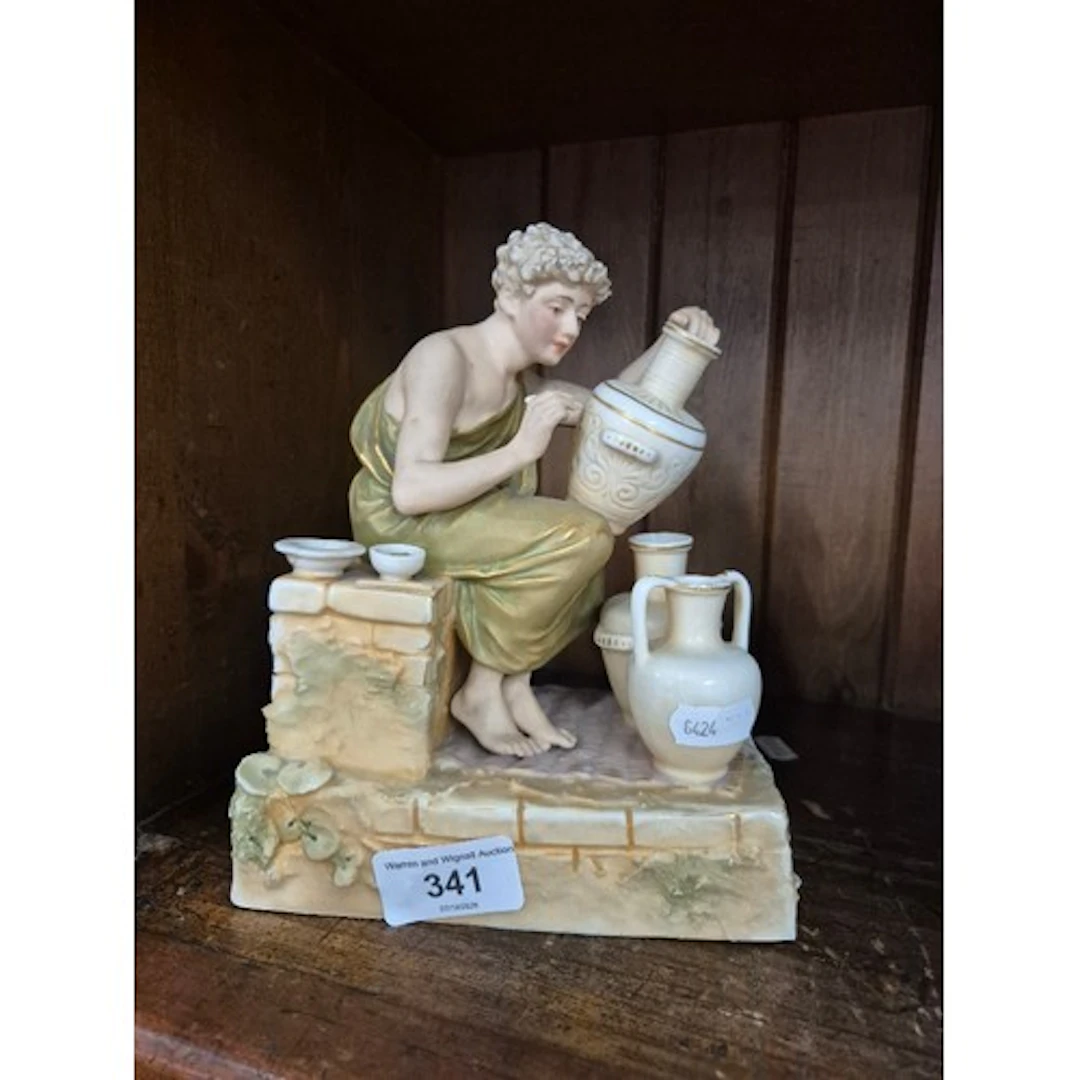 Royal Dux figurine depicting Potter, number 129 to base.