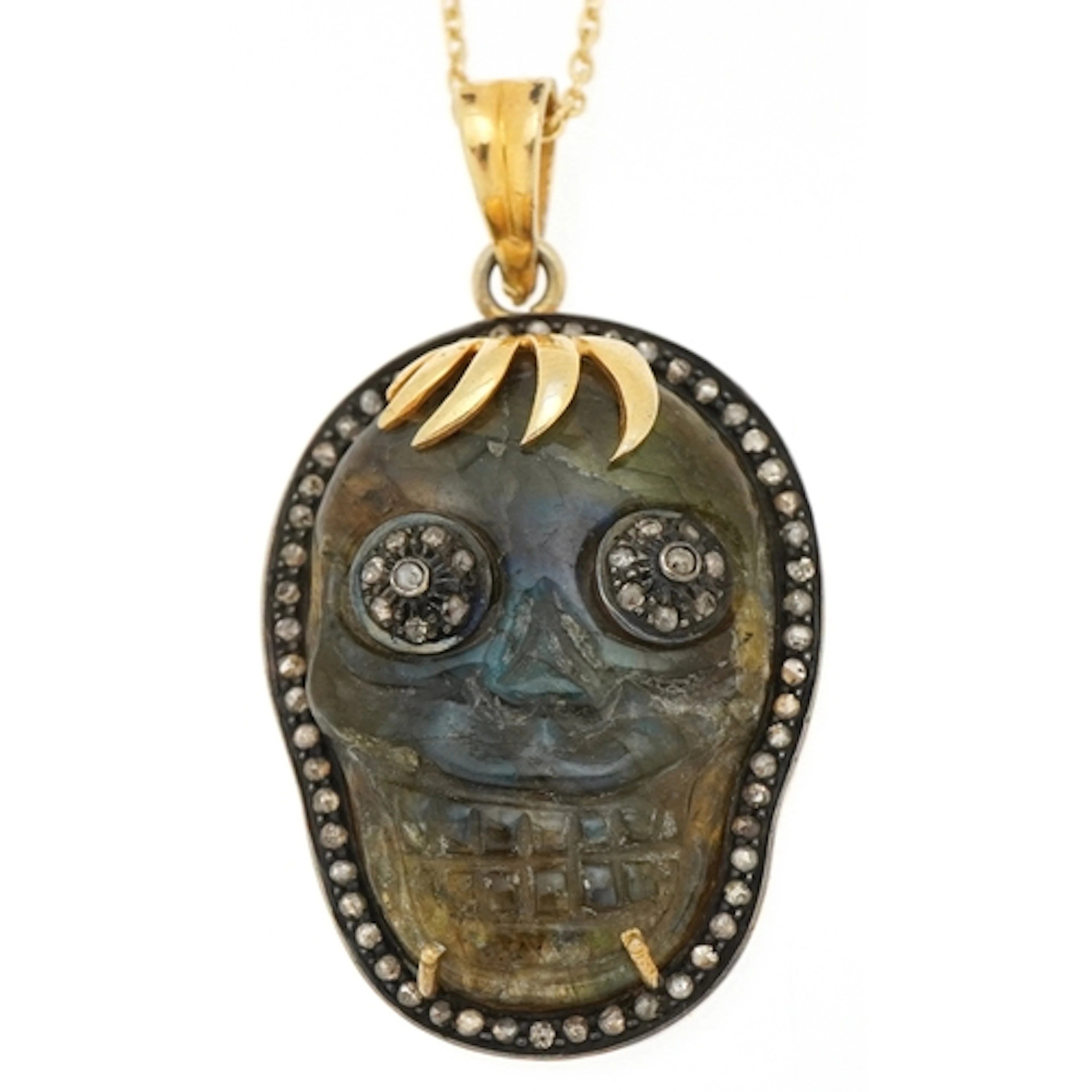 A yellow metal labradorite skull pendant set with rose cut d...