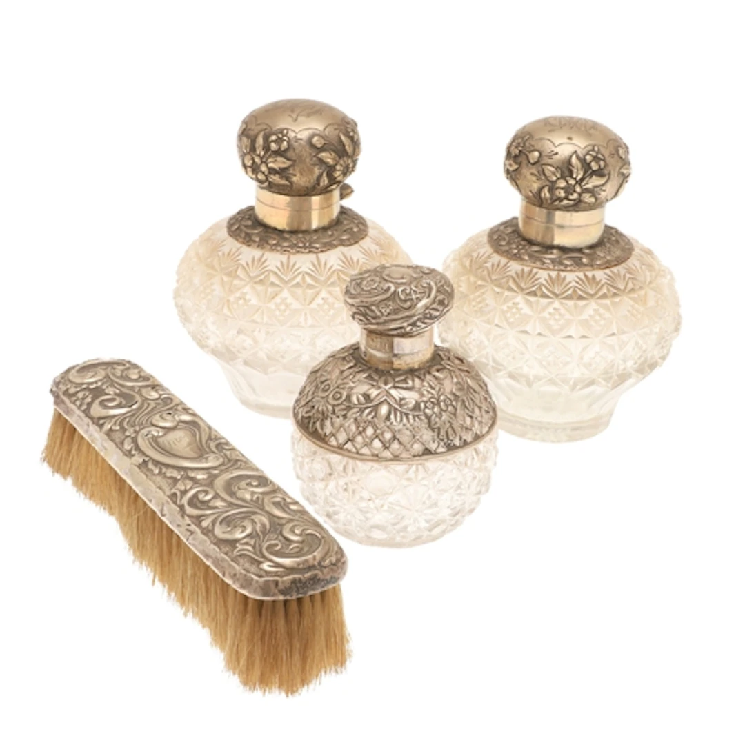 A PAIR OF VICTORIAN SILVER MOUNTED GLASS SCENT BOTTLES. The ...