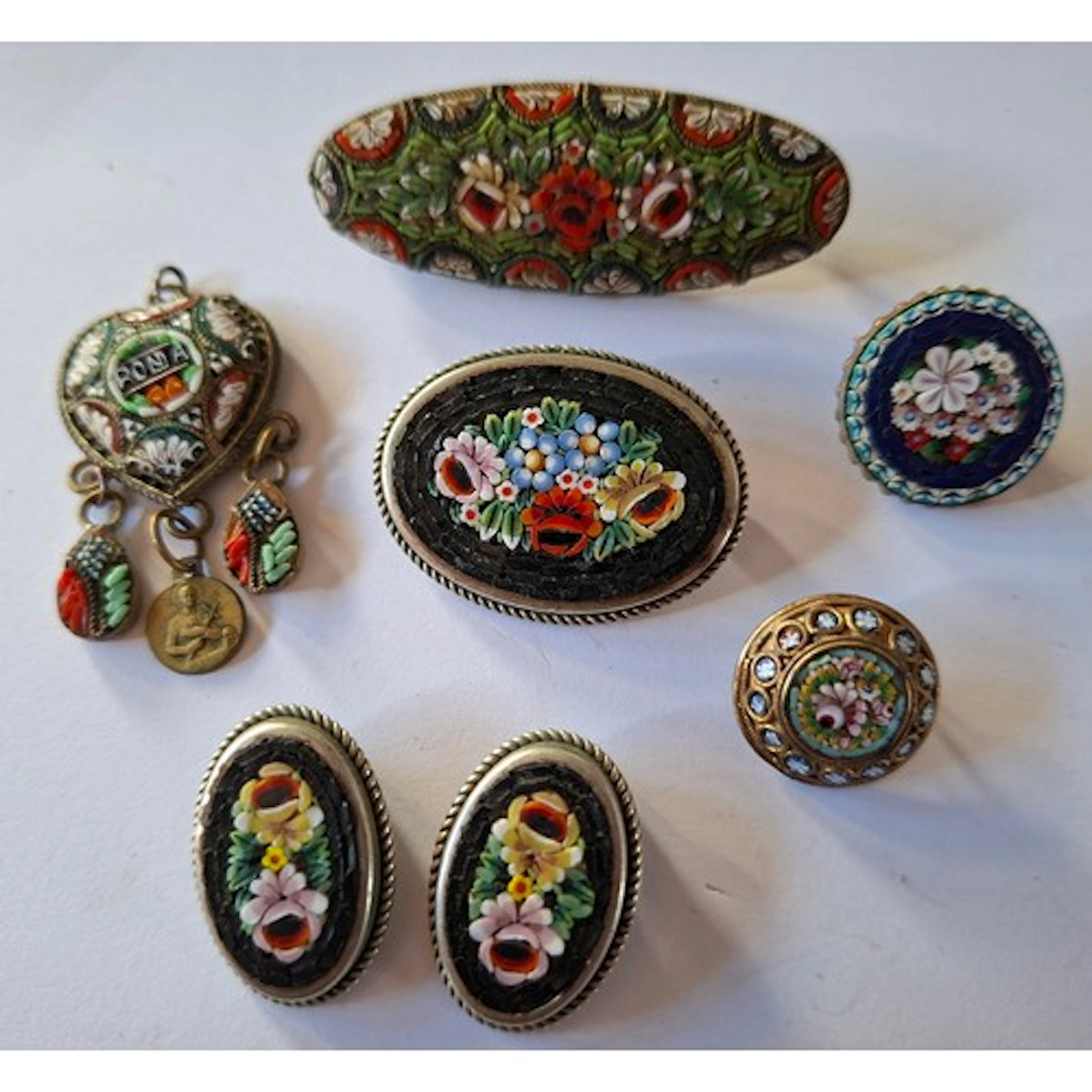 A group of vintage silver tone and gold tone Italian mosaic ...