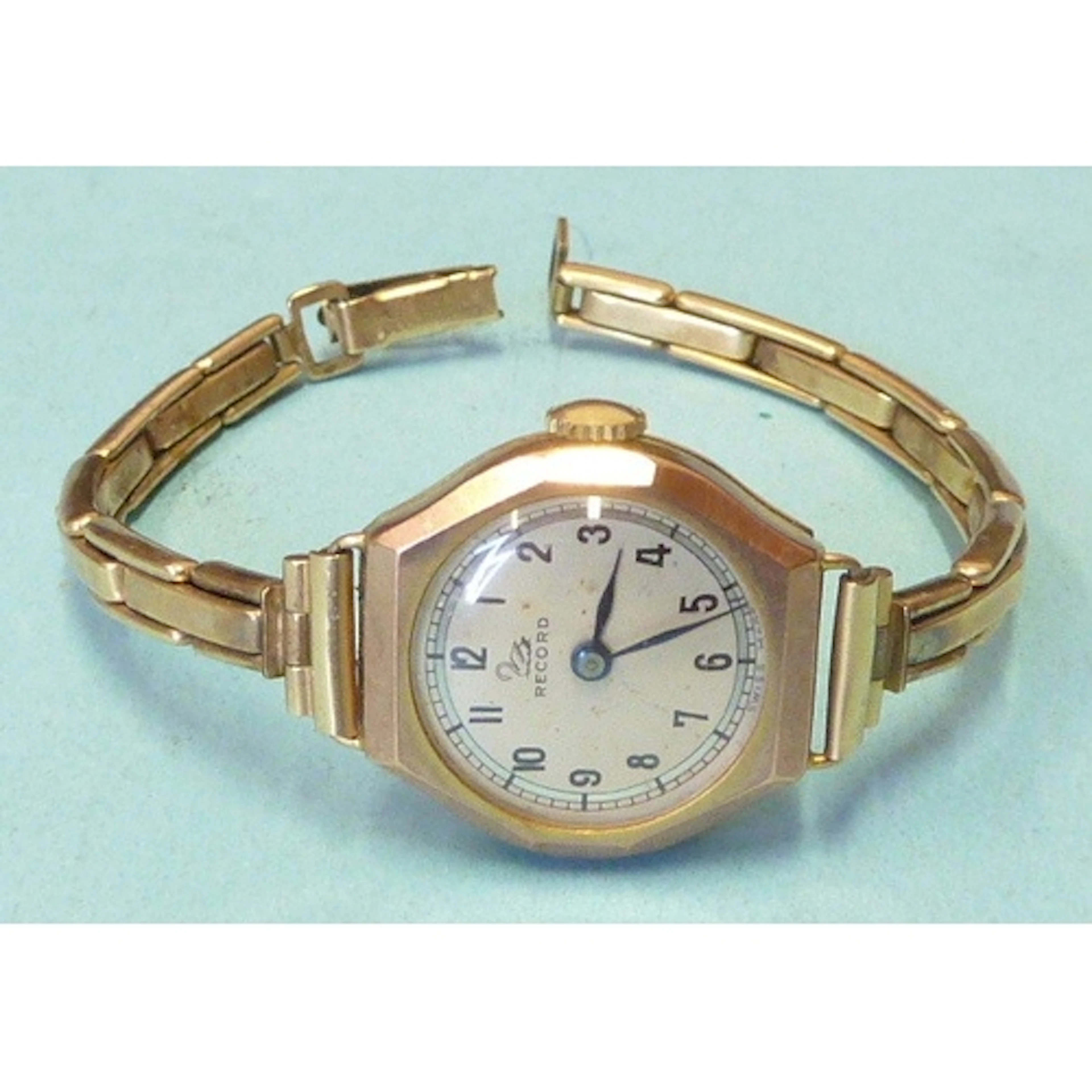 A lady's Record 9ct-gold-cased wrist watch on plated bracele...