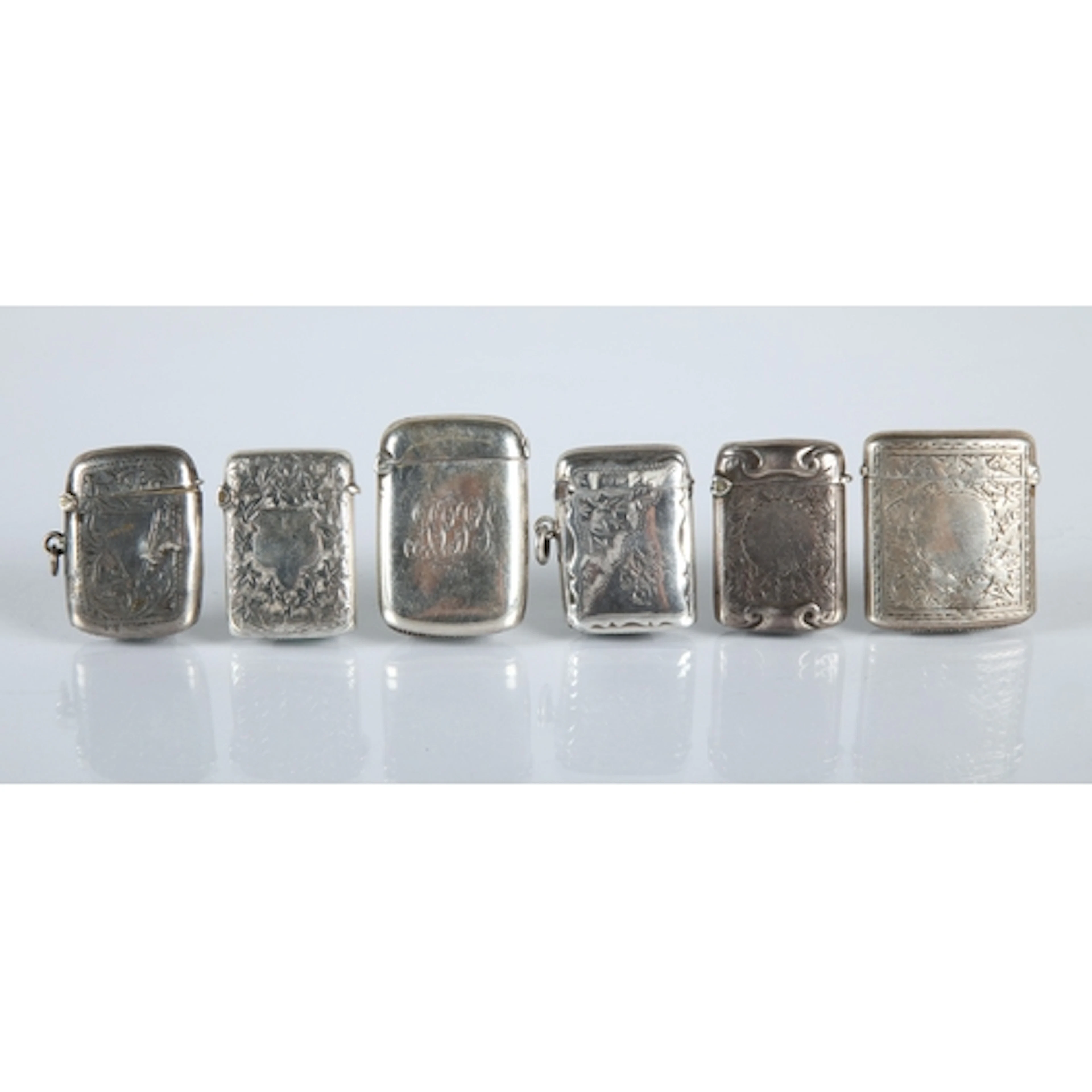 Six silver engraved vesta cases, gross weight 87.7g.
