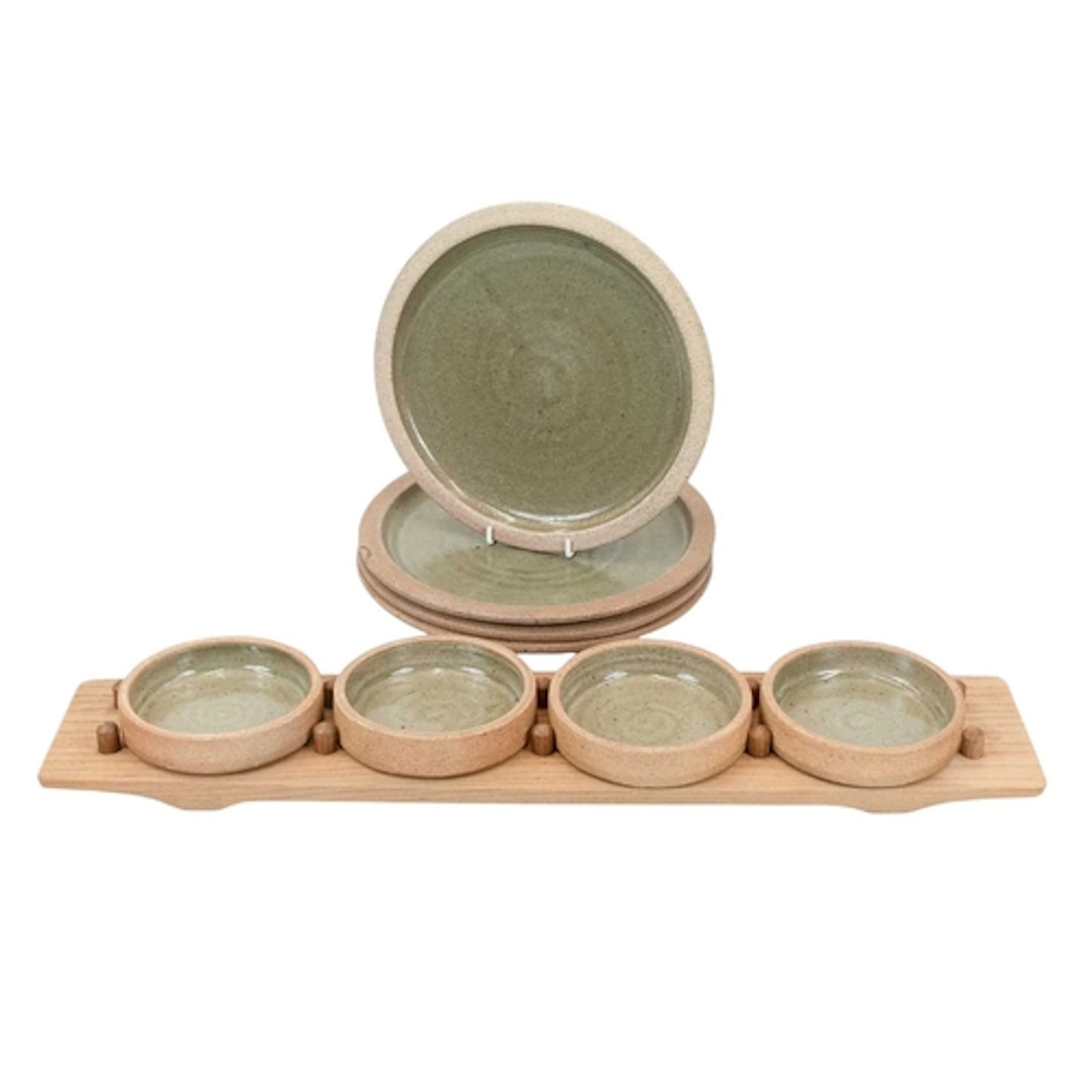 § Leach Pottery A set of four hors d'oeuvre dishes on a wood...