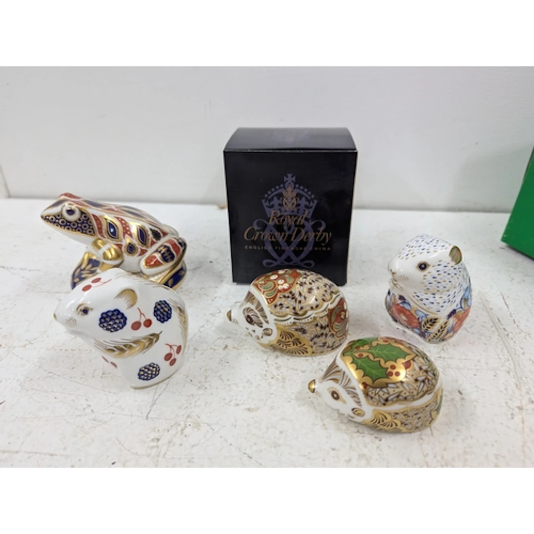 Five Royal Crown Derby paper weights, two with gold stoppers...