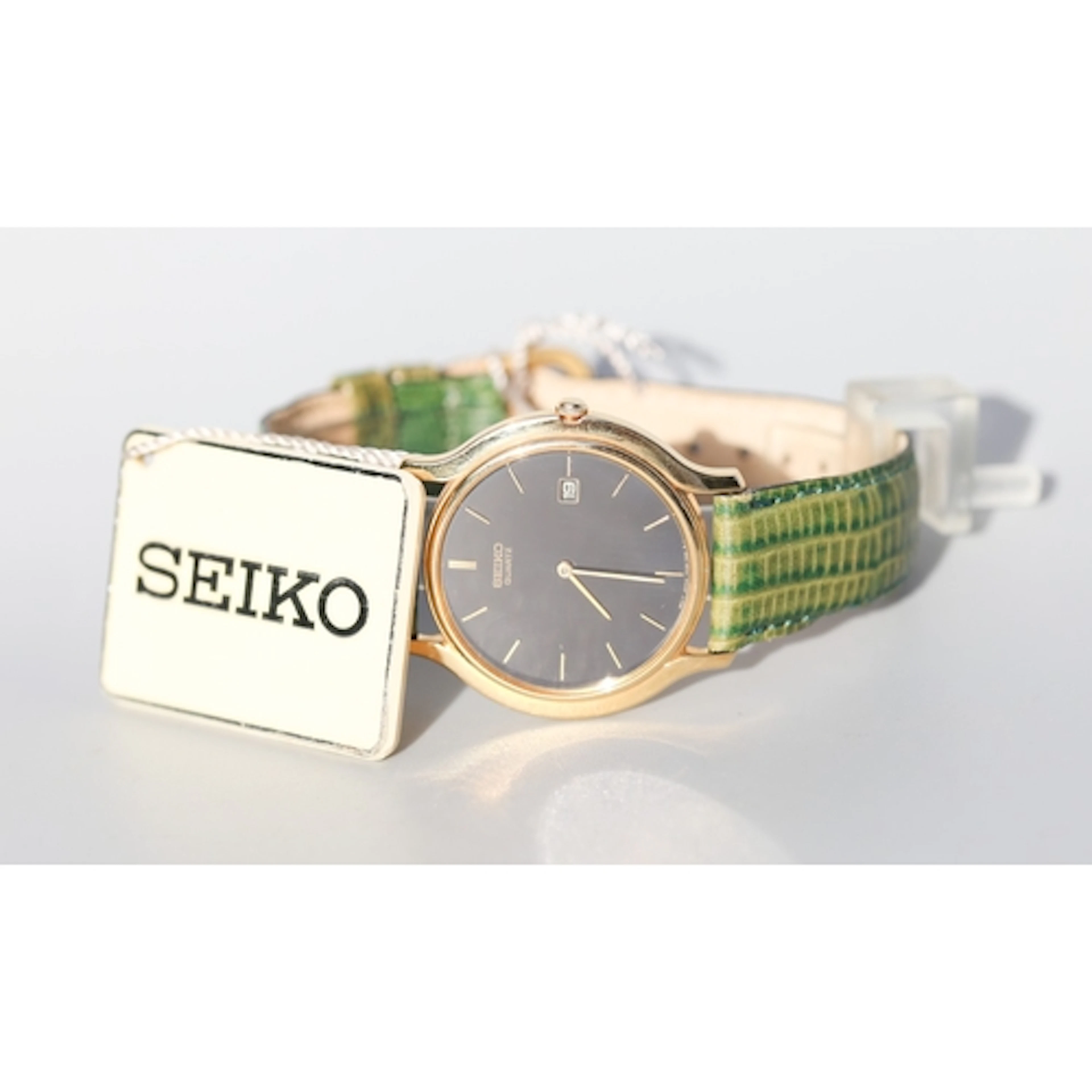 Seiko Unisex Gold Tone Wristwatch, Date Aperture Green Leath...