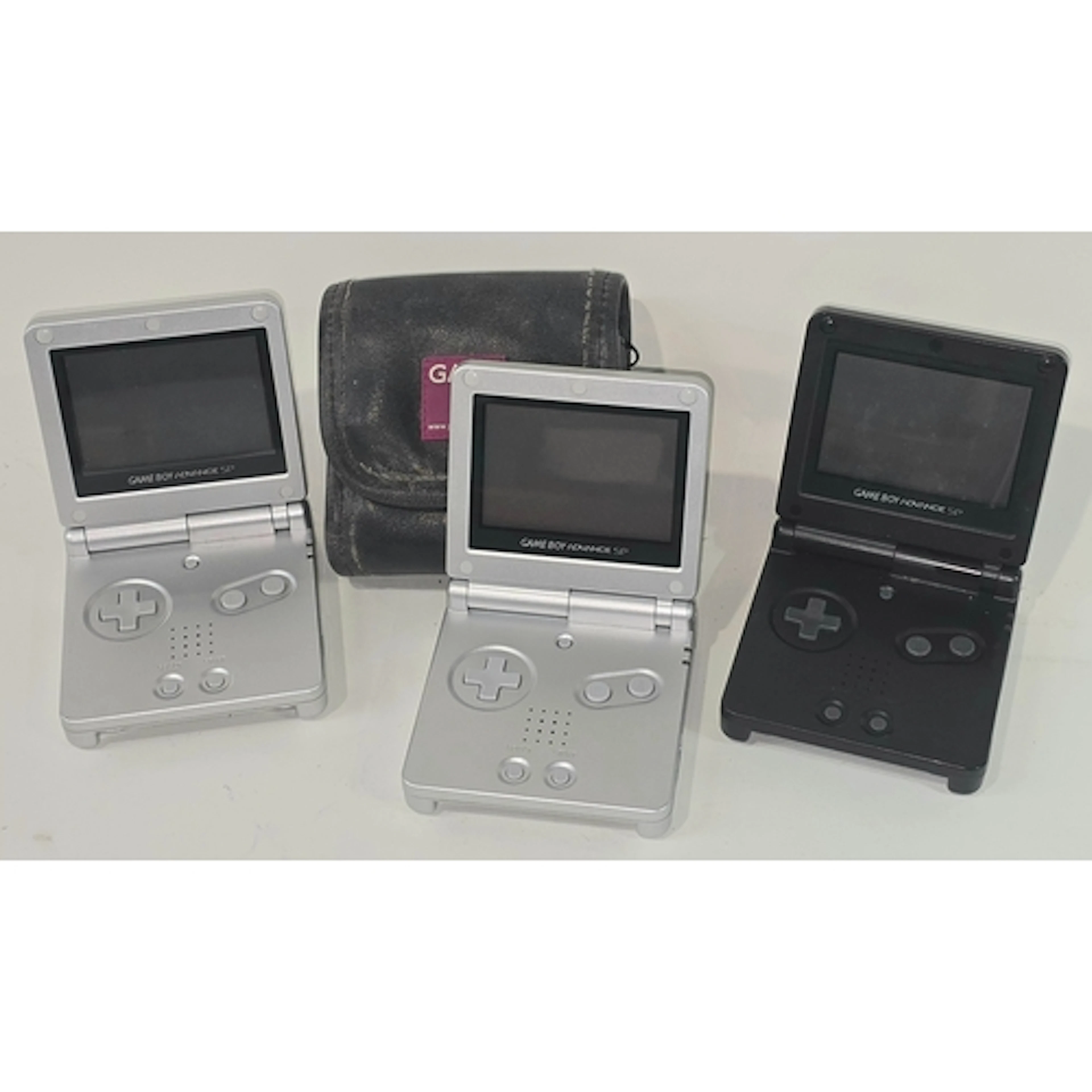 A collection of three Nintendo Game Boy Advance SP consoles....