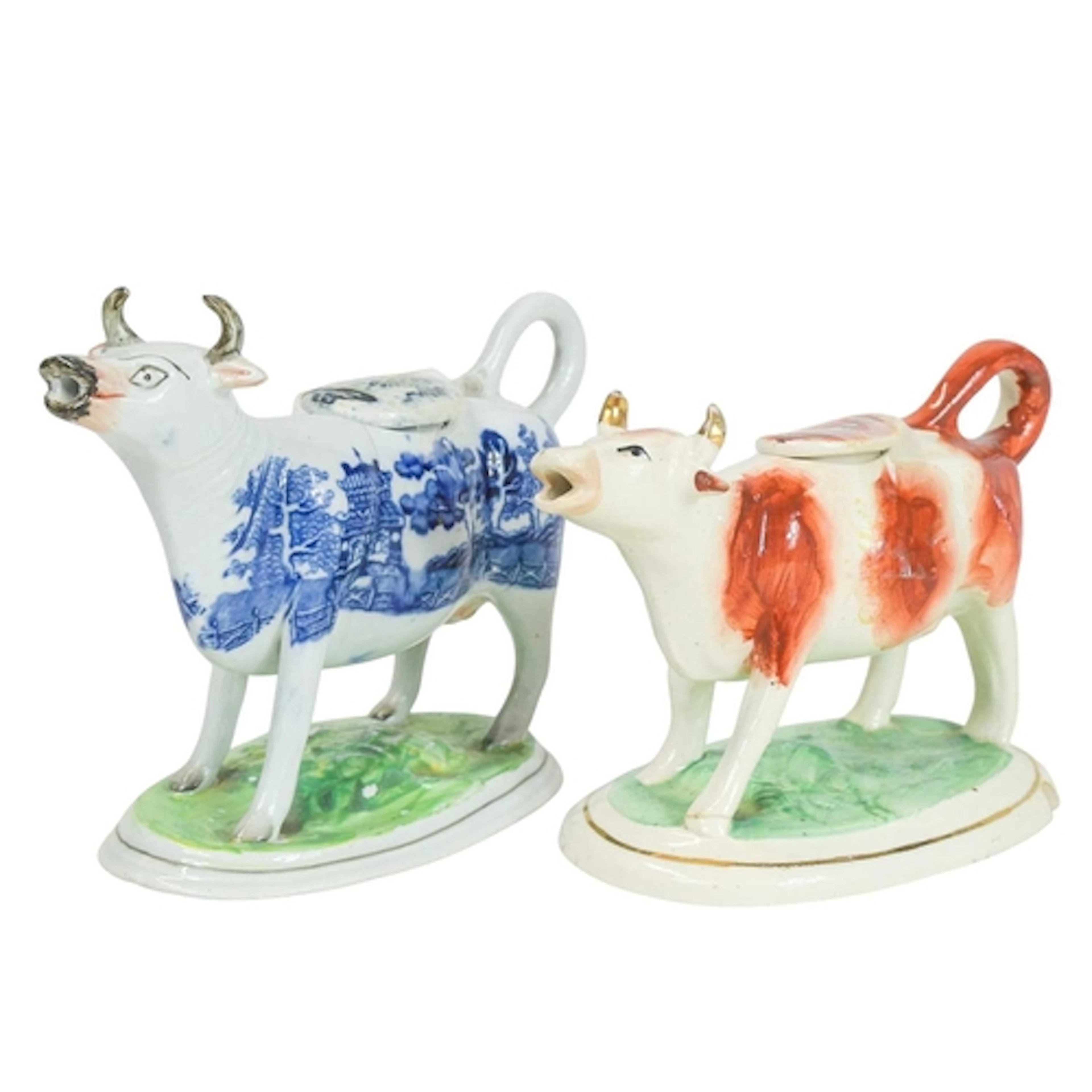 Two 19th century Staffordshire cow creamers. One red and whi...