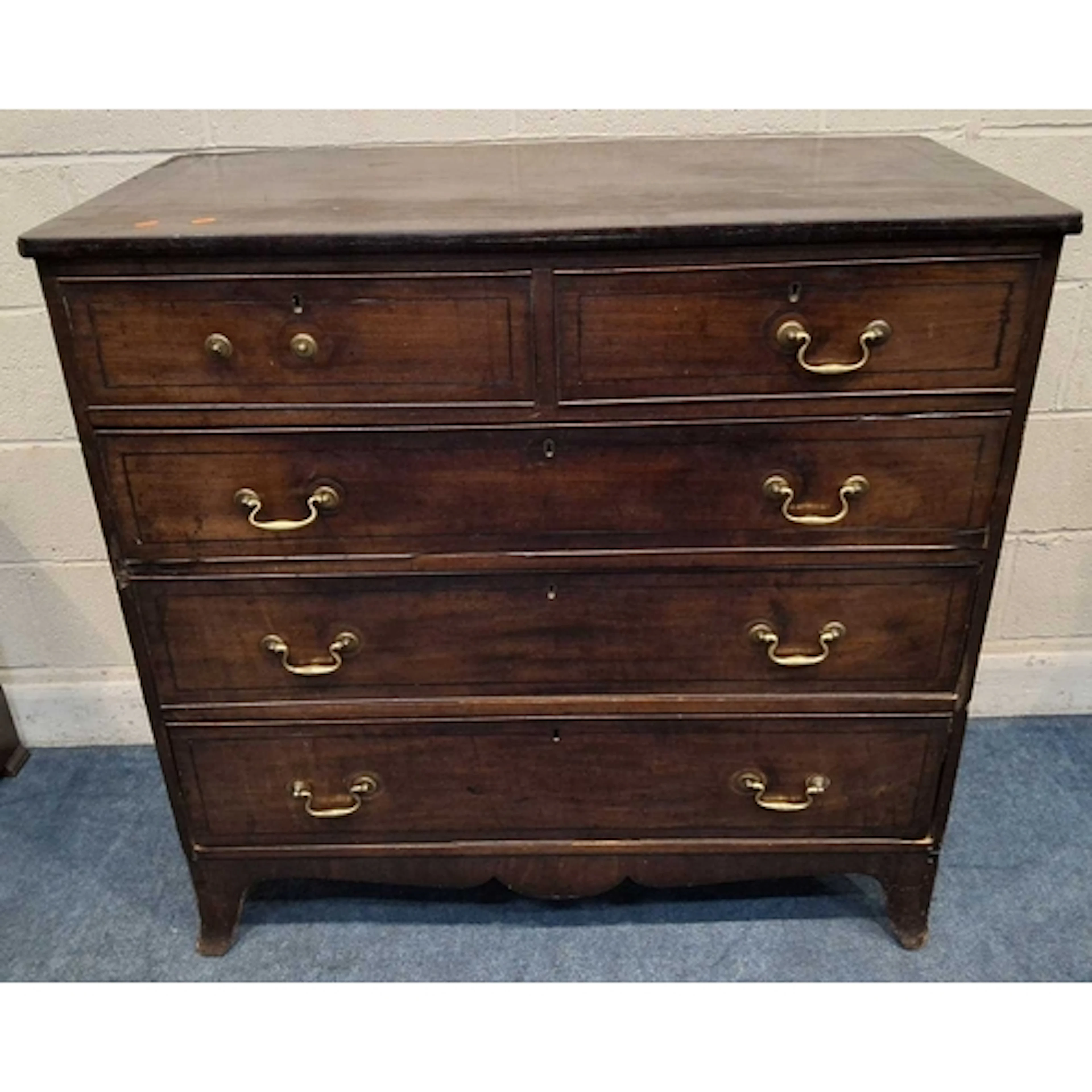 A GEORGIAN MAHOGANY CHEST OF TWO SHORT OVER THREE LONG GRADU...