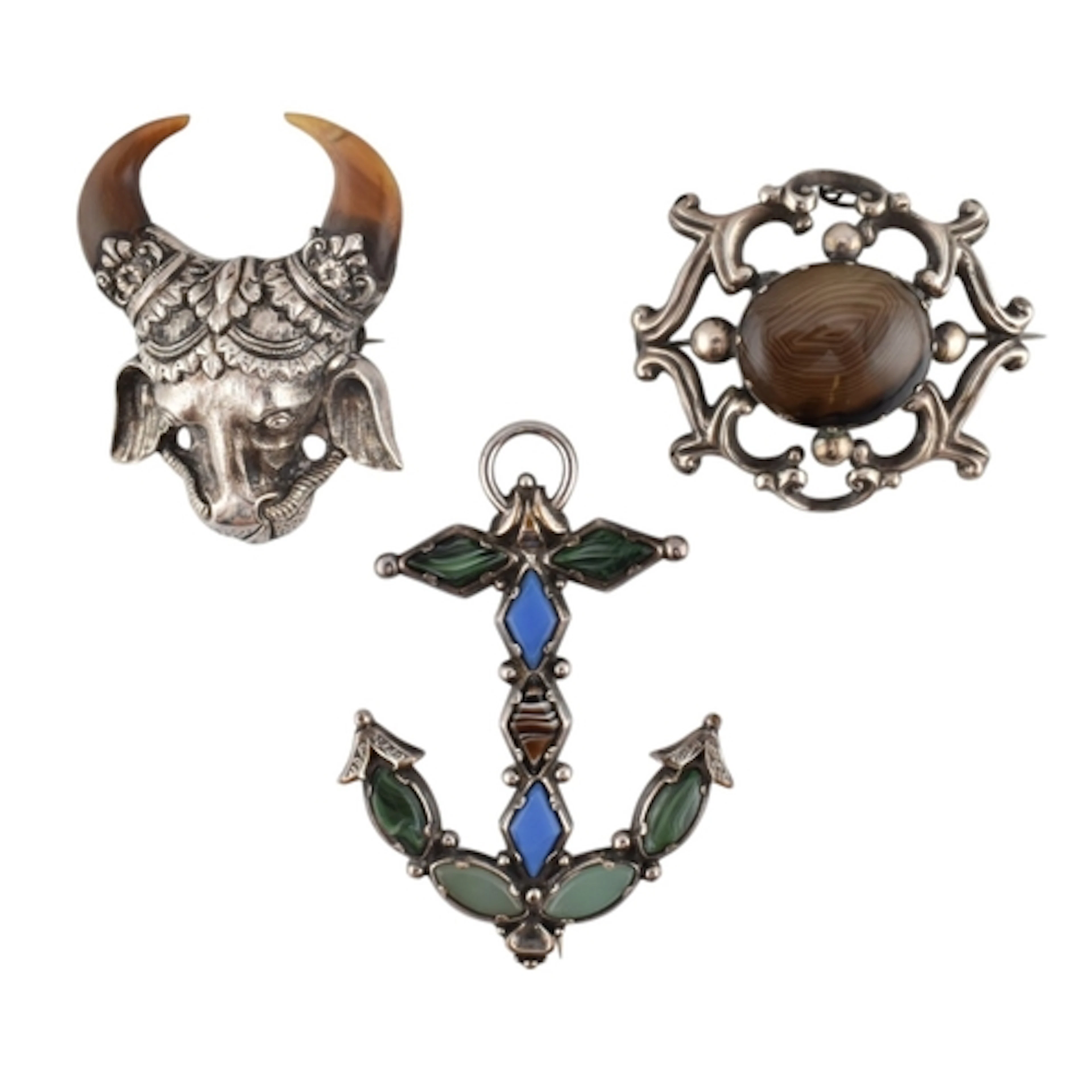 Three white metal statement brooch pins. To include: a white...