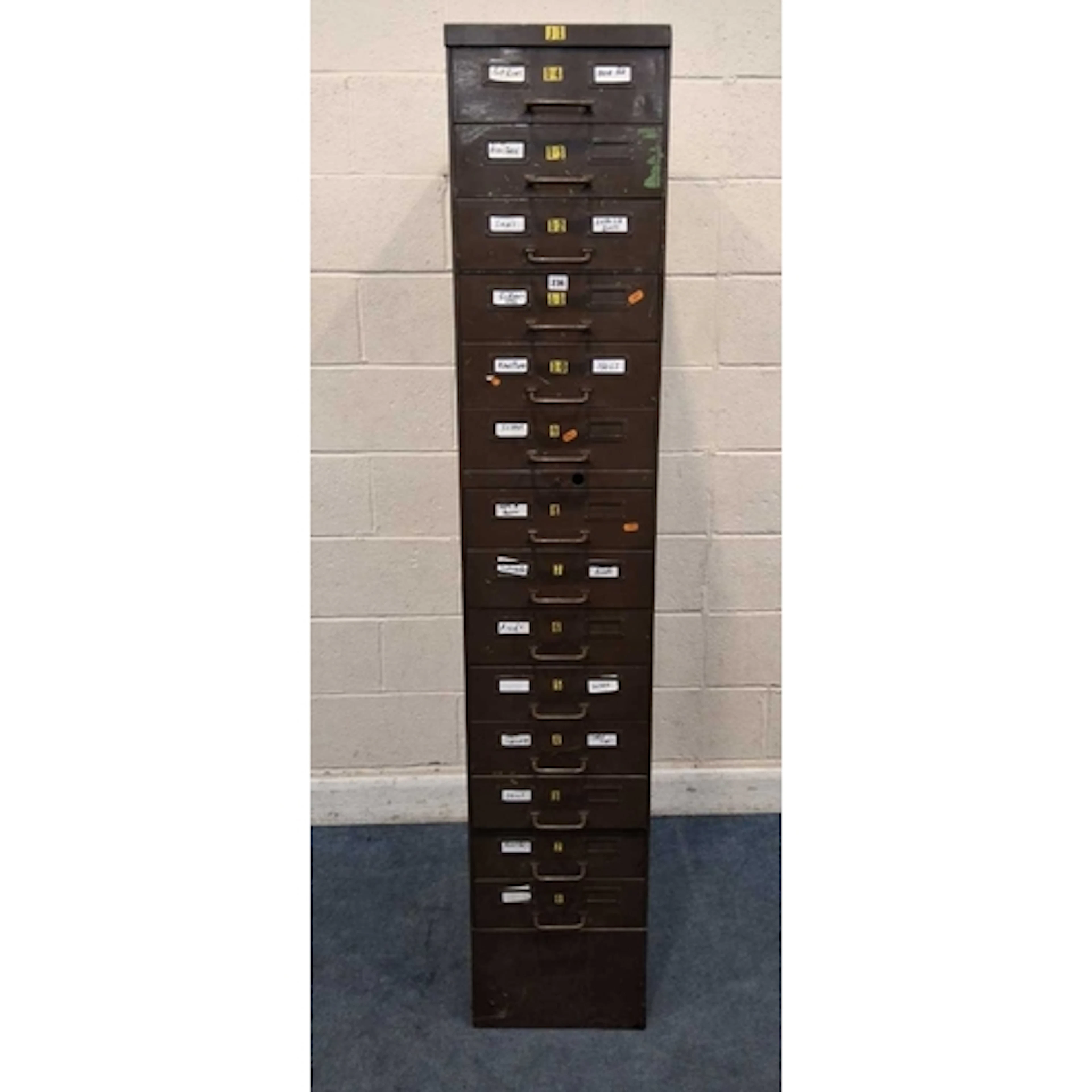 A TALL SLIM INDUSTRIAL METAL FILING CABINET, with fourteen d...