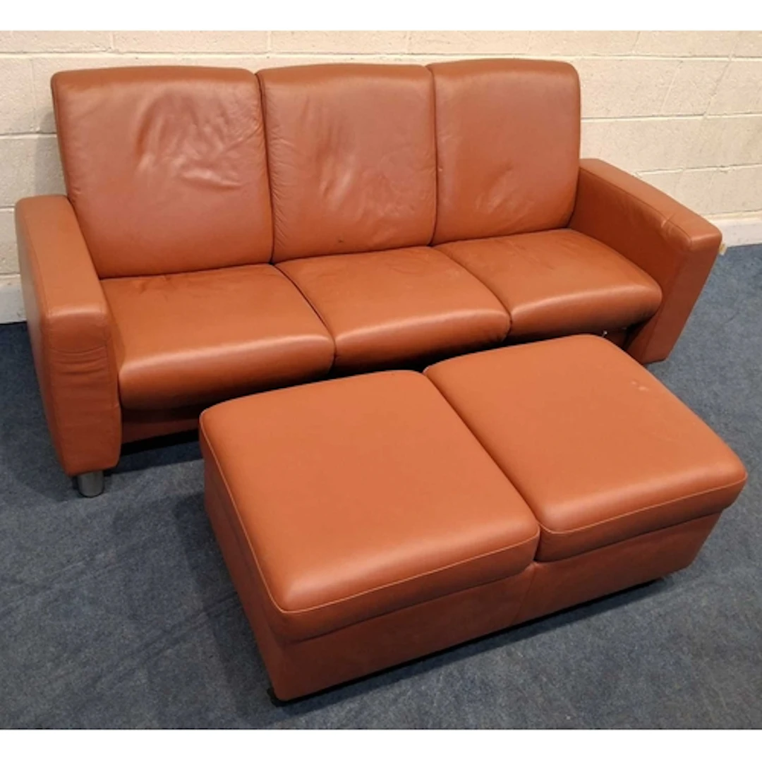 AN EKORNES STRESSLESS LEATHER THREE SEATER RECLINING SOFA, a...