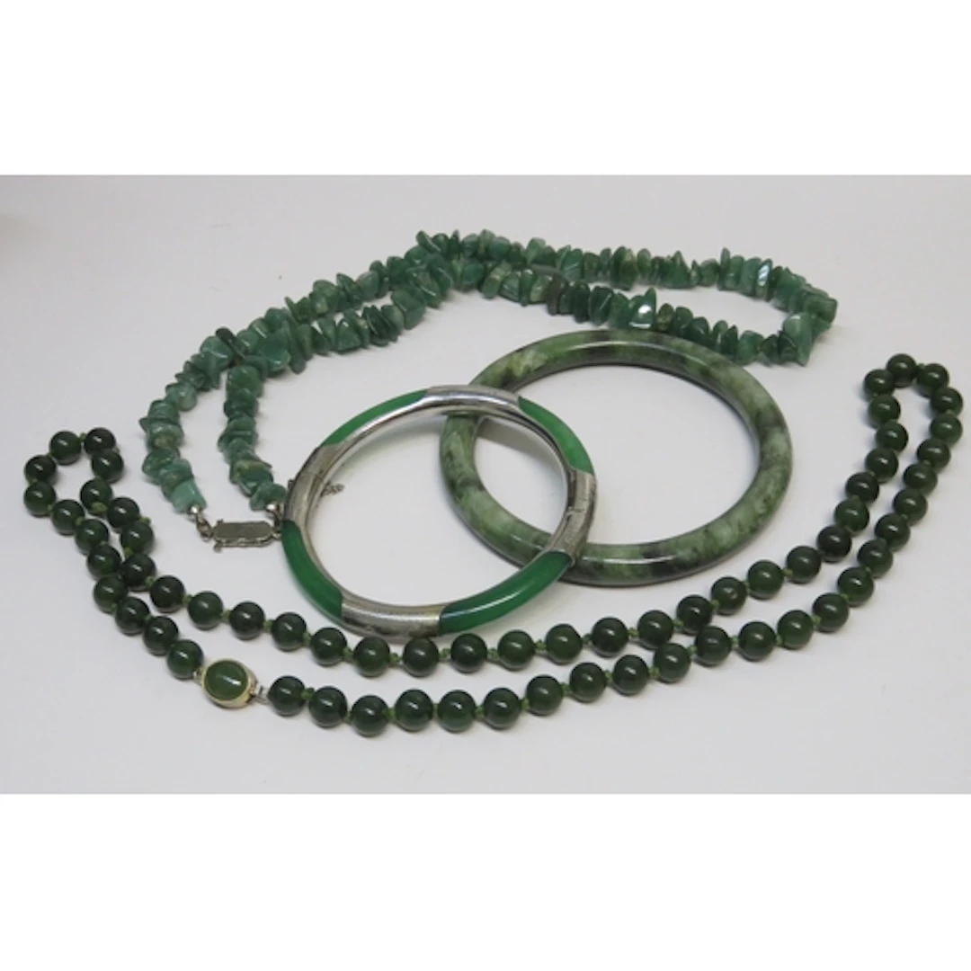 Group of jadeite and green stone bangles and bead necklaces
