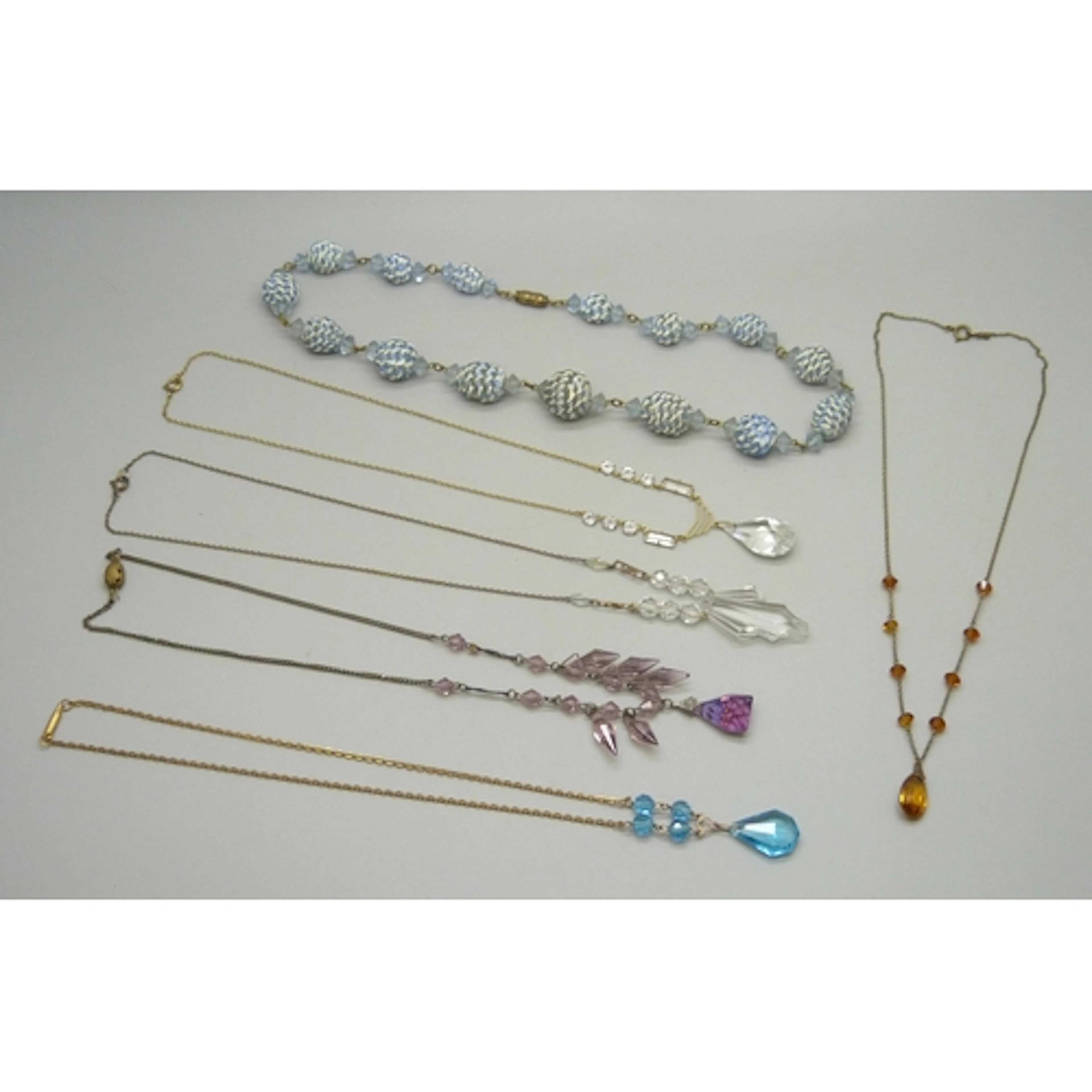 An unusual necklace with hand crafted blue glass beads, toge...